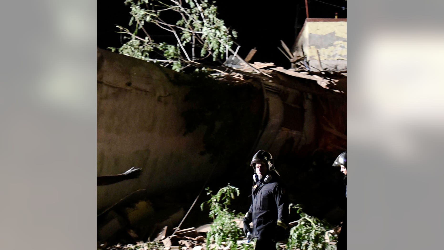 Rescuers and others stand near the site of a fatal train derailment close to the northern city of Thessaloniki, Greece on Sunday, May 14, 2017. The train was traveling on the Athens-Thessaloniki route when it went off the rails near the station at the village of Adendro, 40 kilometers (25 miles) west of Thessaloniki Saturday night. (AP Photo/Giannis Papanikos)