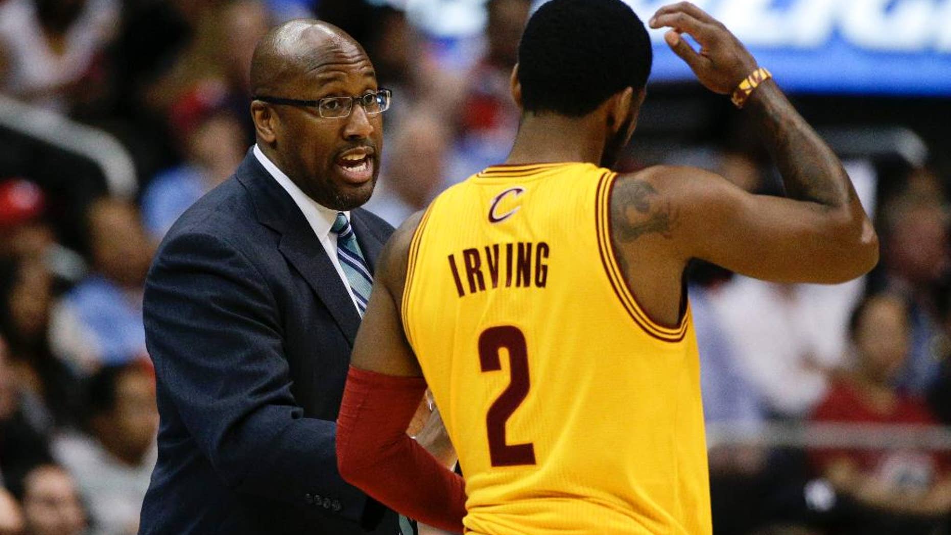 Cleveland Cavaliers's Mike Brown, left, talks to Kyrie Irving during the first half of an NBA basketball game against the Los Angeles Clippers on Sunday, March 16, 2014, in Los Angeles. (AP Photo/Jae C. Hong)