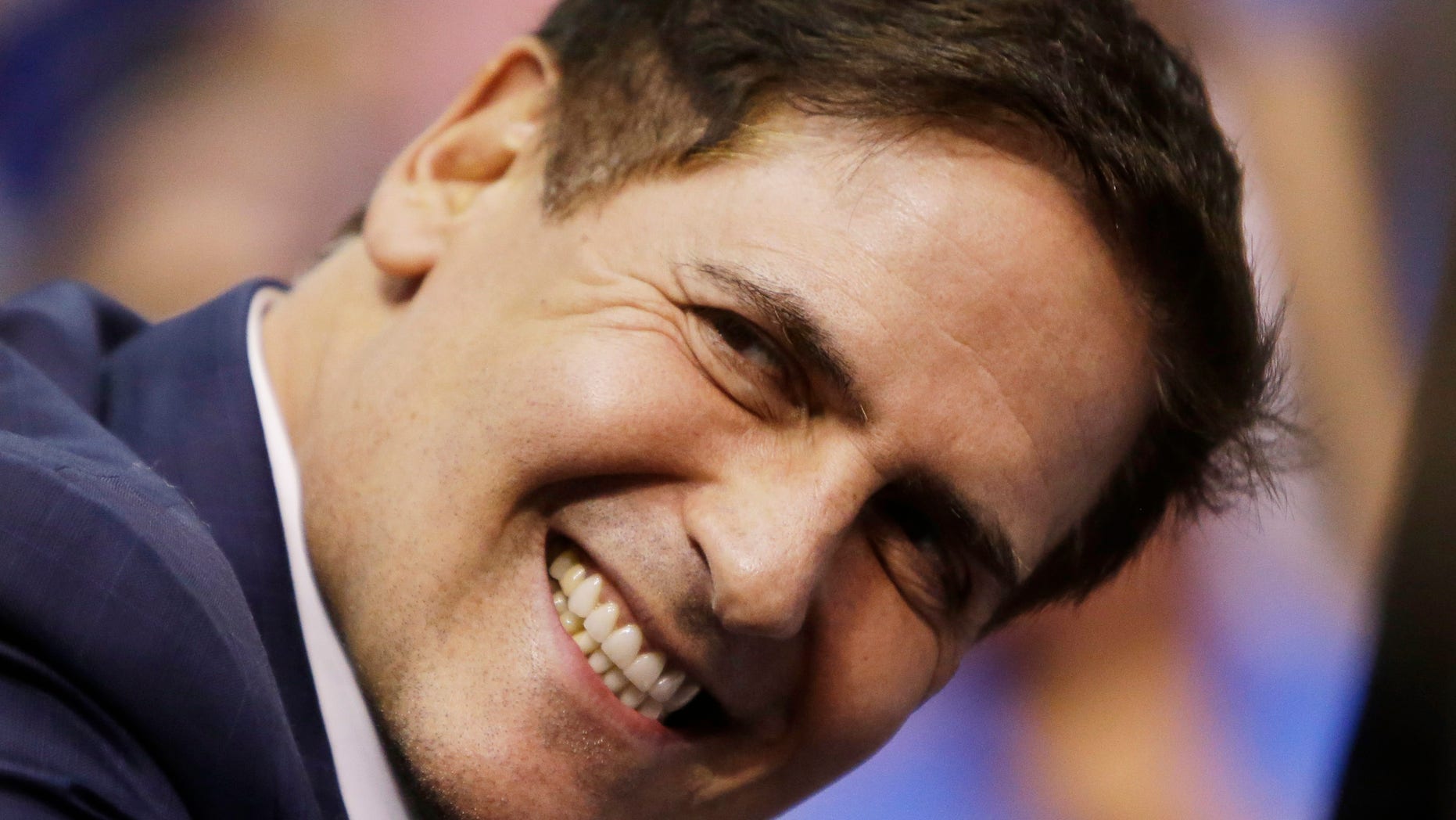 FILE - In this March 28, 2013, file photo, Dallas Mavericks owner Mark Cuban smiles during an NBA game in Dallas on March 28, 2013. Opening arguments in the government's insider-trading case against Cuban begin on Tuesday, Oct. 1, 2013, in federal court in Dallas. (AP Photo/Mike Fuentes, File)