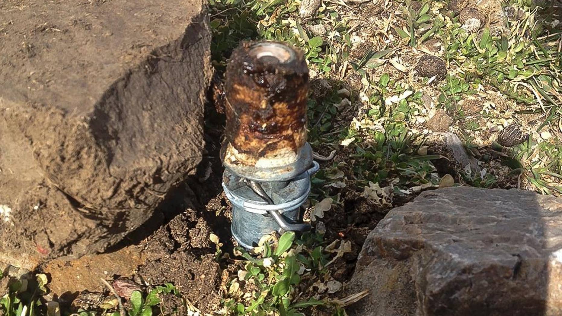 This Thursday, March 16, 2017 photo released by the Bannock County Sheriff's Office shows a cyanide device in Pocatello, Idaho, The cyanide device, called M-44, is spring-activated and shoots poison that is meant to kill predators. The U.S. Department of Agriculture released a statement Friday, March 17, 2017, confirming that workers placed the device that activated Thursday which resulted in the death of a 3-year-old Lab named Casey. Bannock County Sheriff Lorin Nielsen says a 14-year-old boy was taken to a hospital to be tested for cyanide poisoning but was not seriously injured and was released. (Bannock County Sheriff's Office via AP)