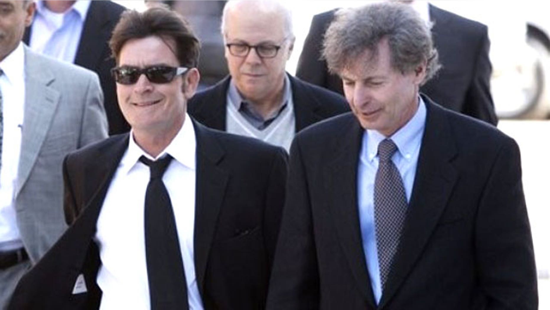 Charlie Sheen (left) and his lawyer leave a court hearing.