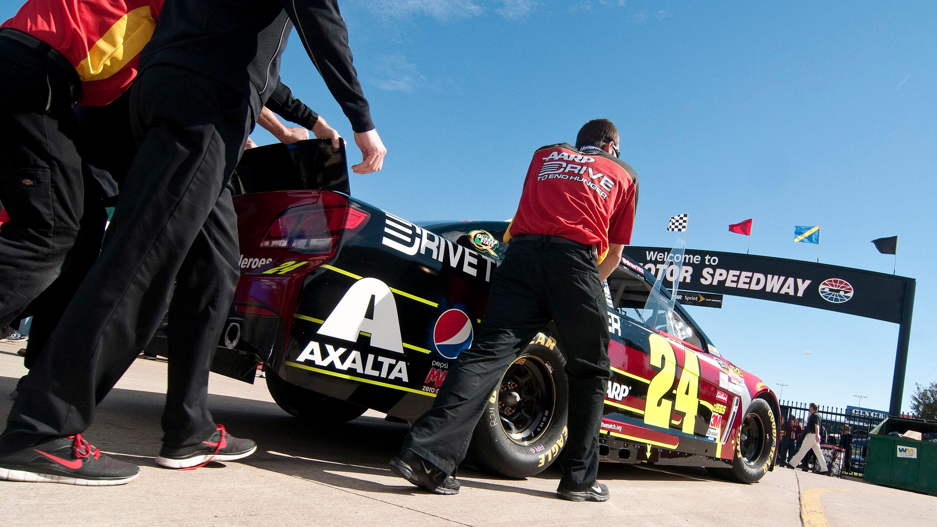 Crew members roll Jeff Gordon's car to an inspection before the NASCAR Sprint Cup series auto race at Texas Motor Speedway in Fort Worth, Texas, Sunday, Nov. 3, 2013. (AP Photo/Ralph Lauer)