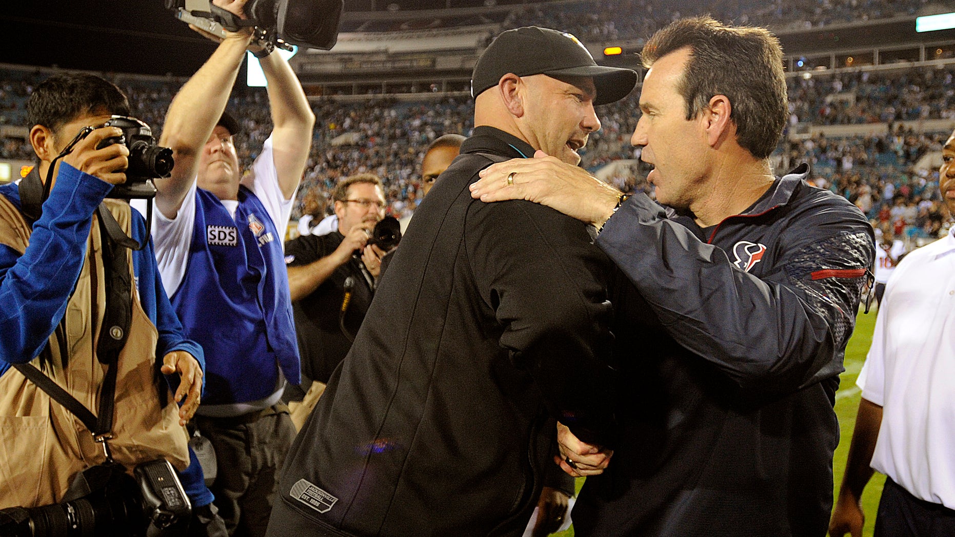 Jacksonville Jaguars head coach Gus Bradley, left, shakes hands with Houston Texans head coach Gary Kubiak, right, after an NFL football game, Thursday, Dec. 5, 2013, in Jacksonville, Fla. Jacksonville beat Houston 27-20. (AP Photo/Stephen Morton)