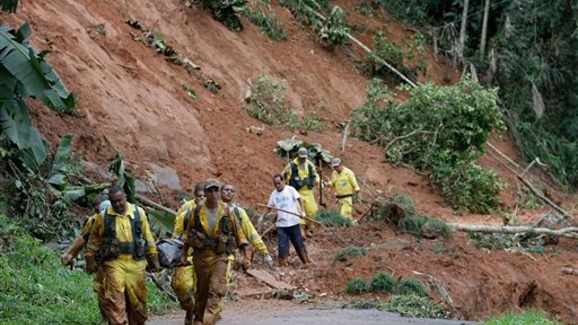 The body of Waldecir Motta de Lima, 48, a victim of a landslide, is carried on a stretcher after being recovered by rescue workers in Cascata de Imbui, Teresopolis, Rio de Janeiro state, Brazil, Saturday, Jan. 15, 2011. After four nights of torrential rains, mudslides have killed more than 500 people in the Rio de Janeiro area. (AP Photo/Silvia Izquierdo)