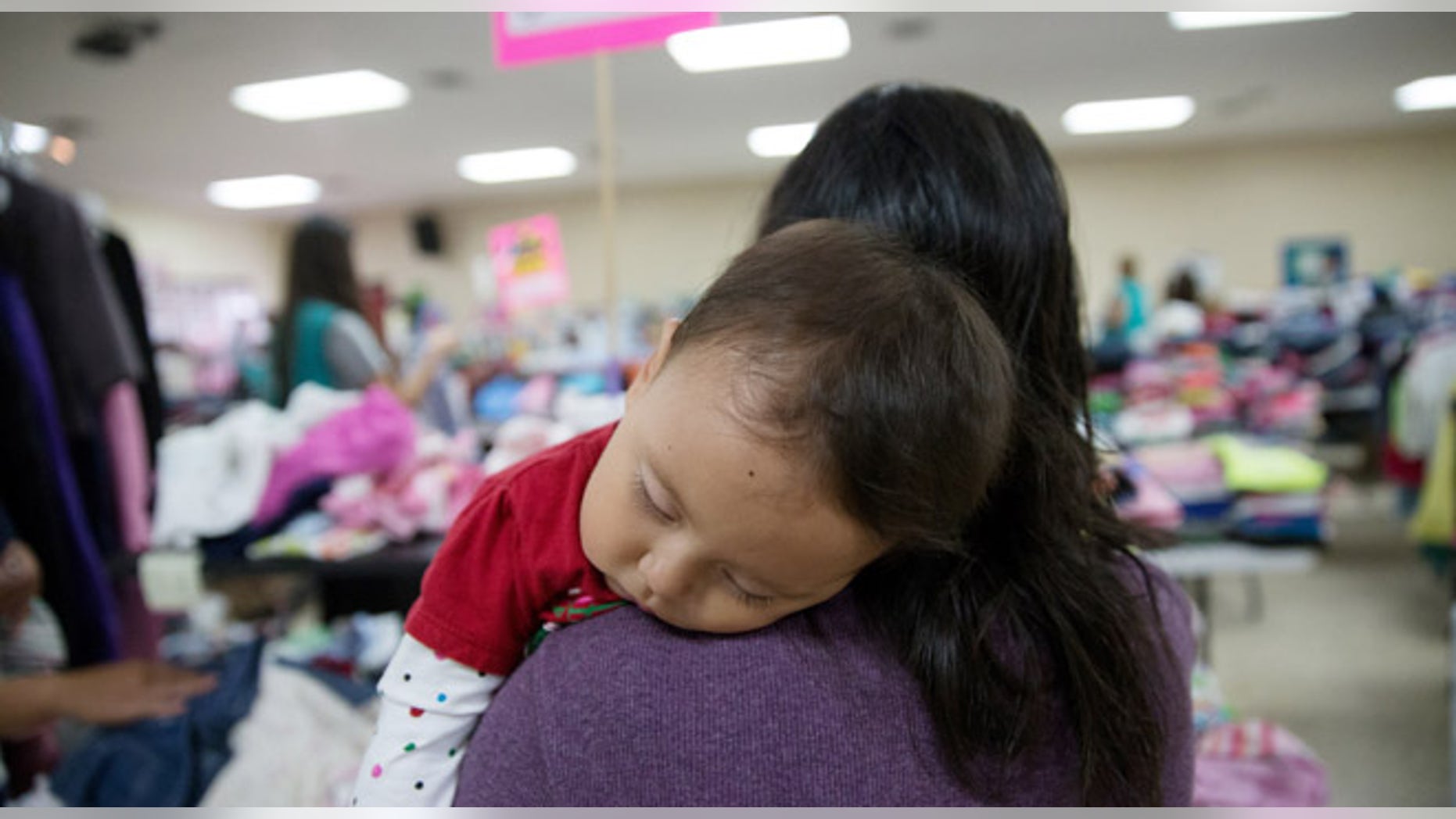 In this April 30, 2105 photo, Gladys Pina, 30, from Honduras holds her 8-month old baby girl at a respite center run by Catholic Charities in McAllen, Texas. She was among nearly two-dozen immigrant mothers who arrived at the center after being released by Border Patrol. Rather than getting locked up in a family detention facility, some families are released by Border Patrol with notices to appear in immigration court. (AP Photo/Seth Robbins)
