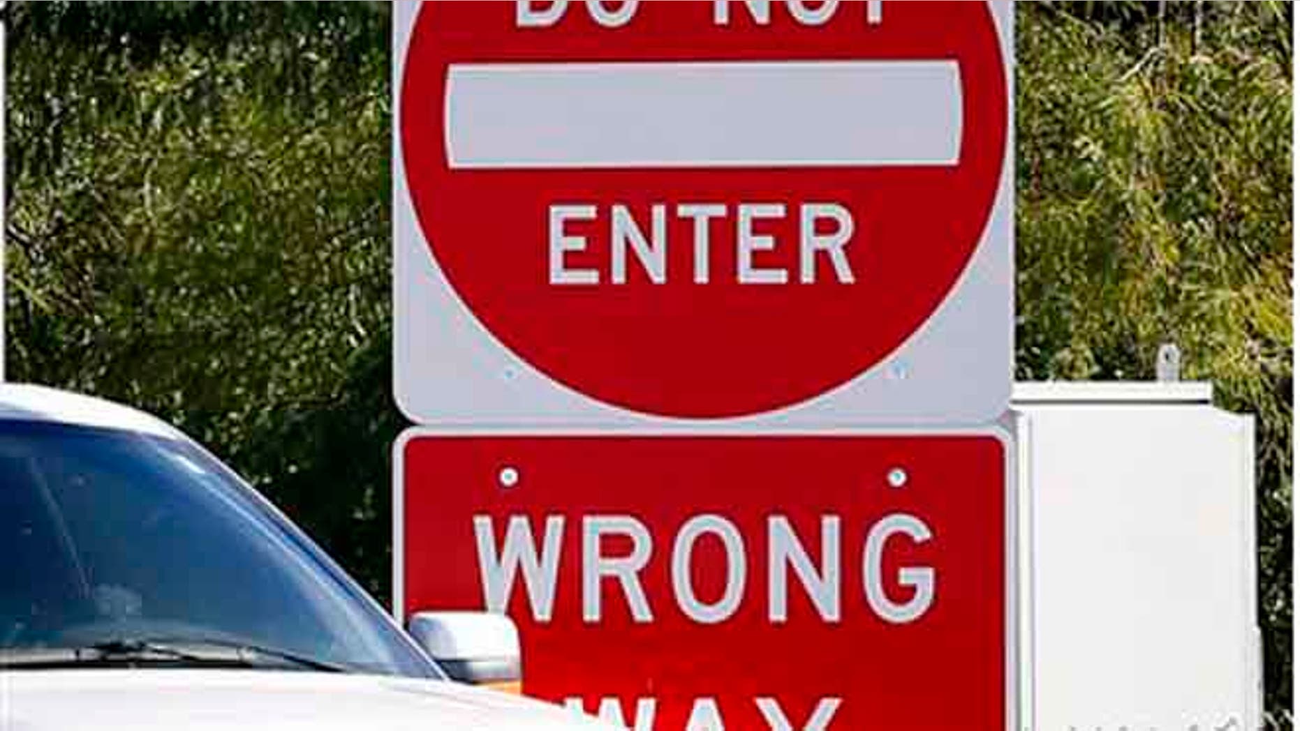 Signs warning drivers not to enter are shown on the Kyrene exit of the Loop 202, Monday, Nov. 23, 2015 in Chandler, Ariz. Arizona transportation officials are responding to a flurry of deadly wrong-way crashes with a plan for a test project on a Phoenix freeway that includes using sensors to detect wrong-way drivers and alert authorities and other motorists. (AP Photo/Matt York)