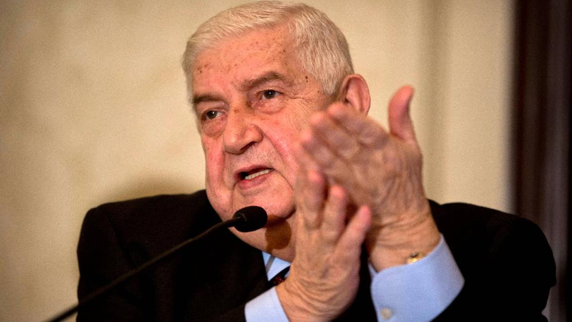FILE -- In this Jan. 13, 2016 file photo, Syrian Foreign Minister Walid al-Moallem addresses a press conference in New Delhi, India. Al-Moallem is on a four-day official visit to India. An internationally-brokered cease-fire for Syria is still viable, al-Moallem said in a TV interview broadcast Monday, Sept. 26, 2016 and President Bashar Assad’s administration is prepared to take part in a unity government. The interview on Mayadeen TV came as a second group of rebel gunmen and their families began evacuating the opposition neighborhood of al-Waer neighborhood in Homs, in central Syria this month. (AP Photo/Saurabh Das, File)
