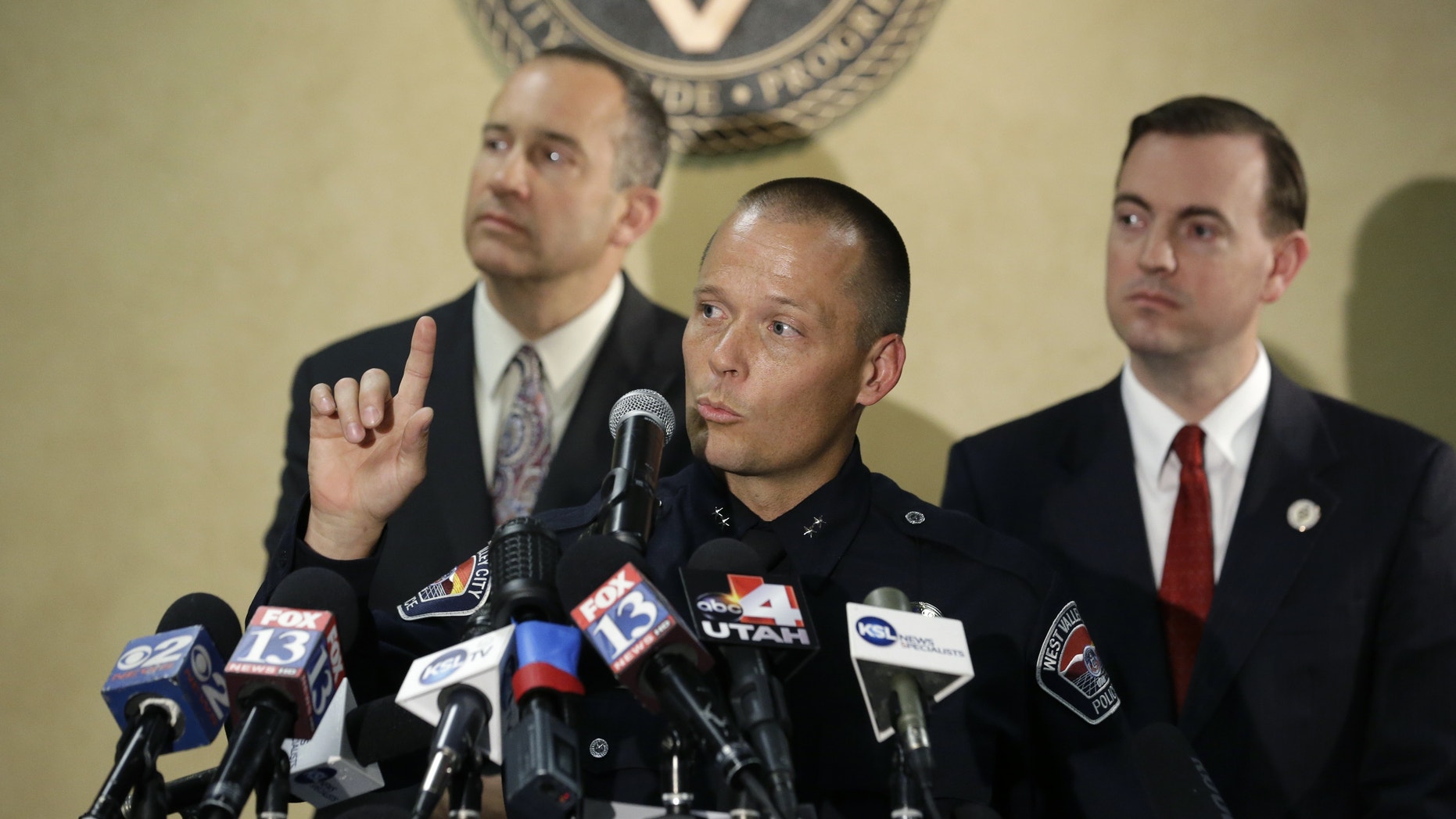 West Valley City Deputy Police Chief Mike Powell, center, makes remarks during a news conference, while West Valley City Mayor Mike Winder, right, and West Valley City Manager Wayne Pyle, left, look on Monday, May 20, 2013, in West Valley City, Utah. Citing a lack of leads, a police agency said Monday that it is closing the active investigation of the disappearance of Susan Powell, a Utah mother whose now-dead husband was a prime suspect. (AP Photo/Rick Bowmer)