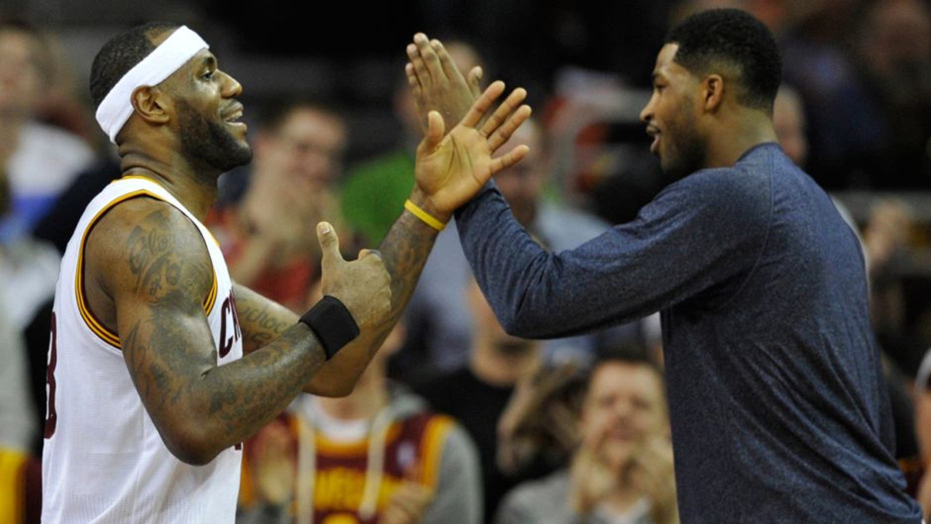 Feb 5, 2015; Cleveland, OH, USA; Cleveland Cavaliers forward LeBron James (left) celebrates with center Tristan Thompson (13) in the second quarter against the Los Angeles Clippers at Quicken Loans Arena. Mandatory Credit: David Richard-USA TODAY Sports