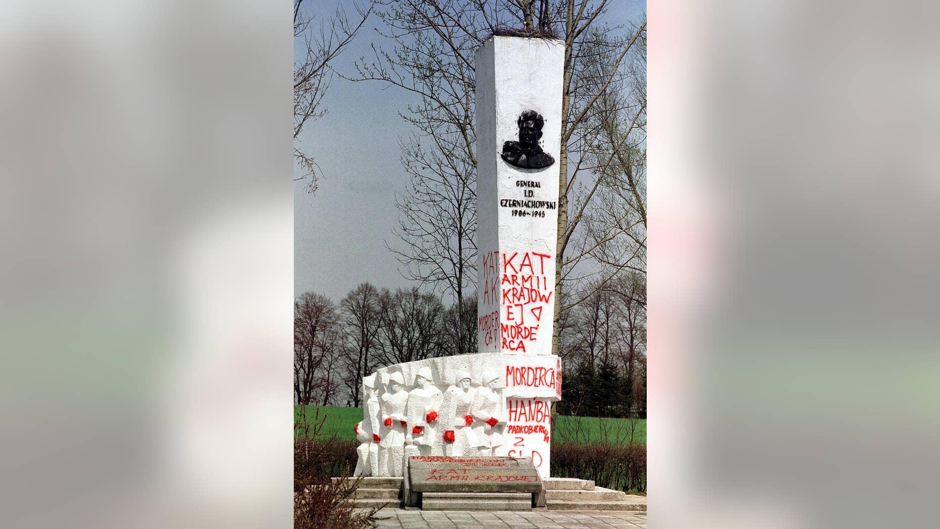 FILE- In this April 30, 2001 file photo taken in Pieniezno, Poland, graffiti with insults like “Murderer” and “Shame” can be seen on a memorial to Soviet General Ivan Chernyakhovsky, who is considered a symbol of the imposition of communism in Poland, but a national hero in Russia. Russian Ambassador Sergey Andreev on Friday described the Soviet's 1939 invasion of Poland as an act of self-defense, not aggression. The comment prompted Poland's Foreign Ministry to declare Saturday, Sept. 26, 2015, that the ambassador "undermines historical truth" and seems to be trying to justify Stalinist crimes. (AP Photo/Wojtek Jakubowski, file) POLAND OUT