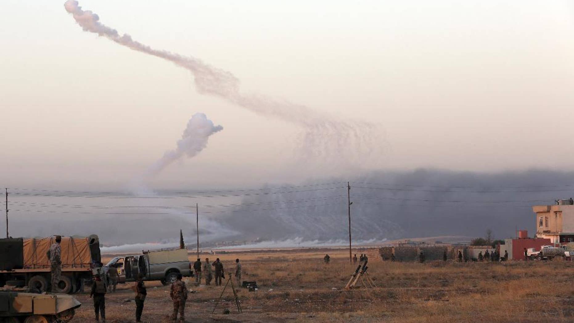 Smoke rises in nearby Mosul as Iraq's elite counterterrorism forces advance towards the city, Iraq, Thursday, Oct. 20, 2016. Iraqi special forces charged into the Mosul battle Thursday with a pre-dawn advance on a nearby town held by the Islamic State group, a key part of a multi-pronged assault on eastern approaches to the besieged city. (AP Photo/Khalid Mohammed)