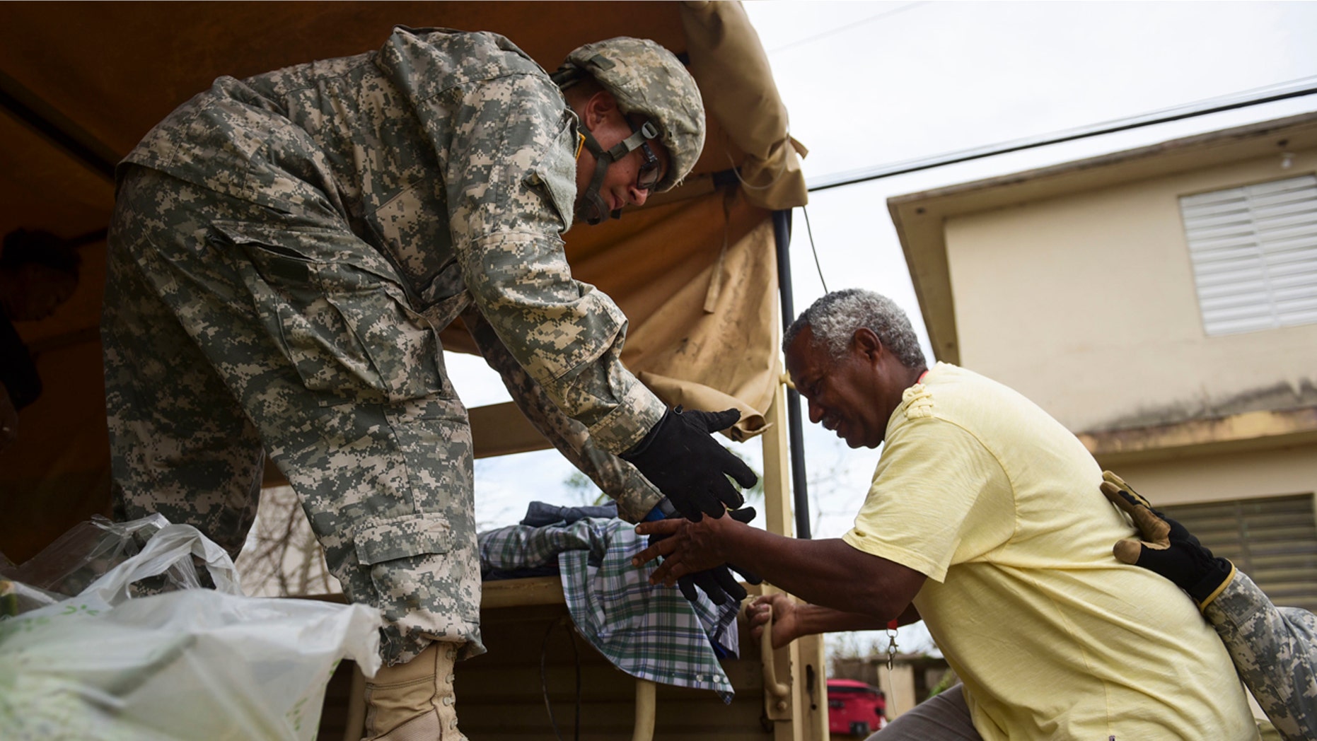 National Guard personnel evacuate Toa Ville resident Luis Alberto Martinez after the passing of Hurricane Maria, in Toa Baja, Puerto Rico, Sept. 22, 2017.