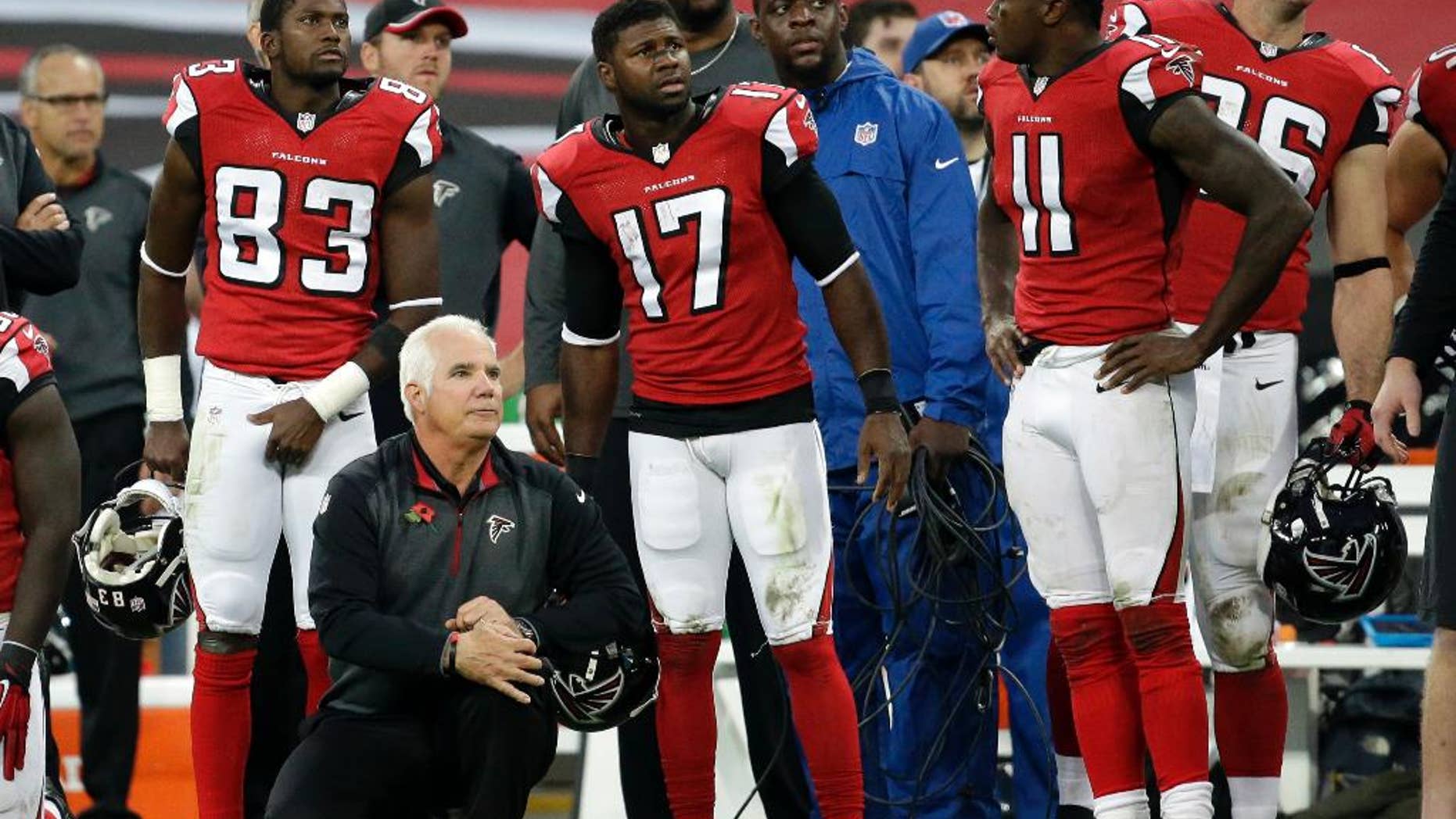 Atlanta Falcons head coach Mike Smith watches as Detroit Lions kicker Matt Prater (5) kicks the game winning field goal in the second half of the NFL football game at Wembley Stadium, London, Sunday, Oct. 26, 2014. The Loins won 22-21. (AP Photo/Matt Dunham)