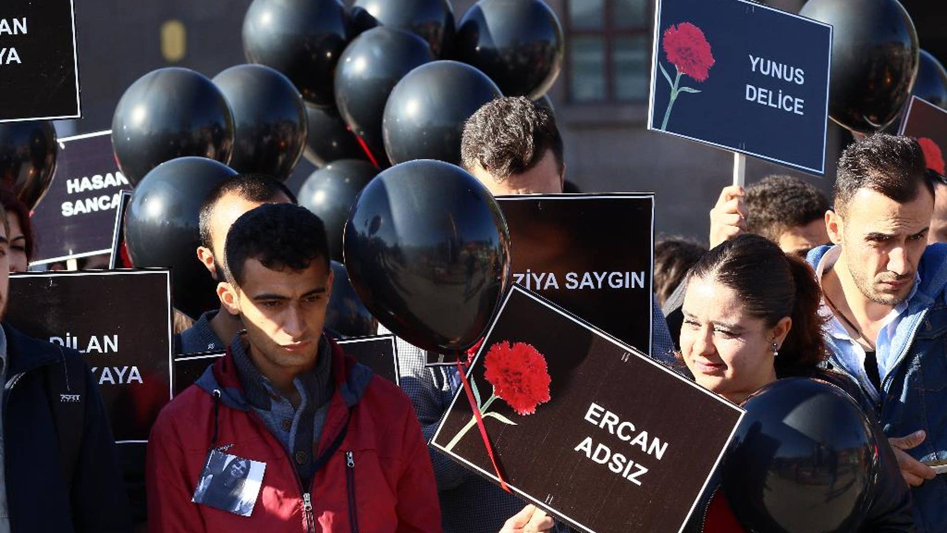 Members of youth organzations hold names of victims and black balloons as they gather at the site of twin explosions that killed 102 people and injured hundreds others more than two weeks ago outside the main train station in Ankara, Turkey, Monday, Oct. 26, 2015. (AP Photo)