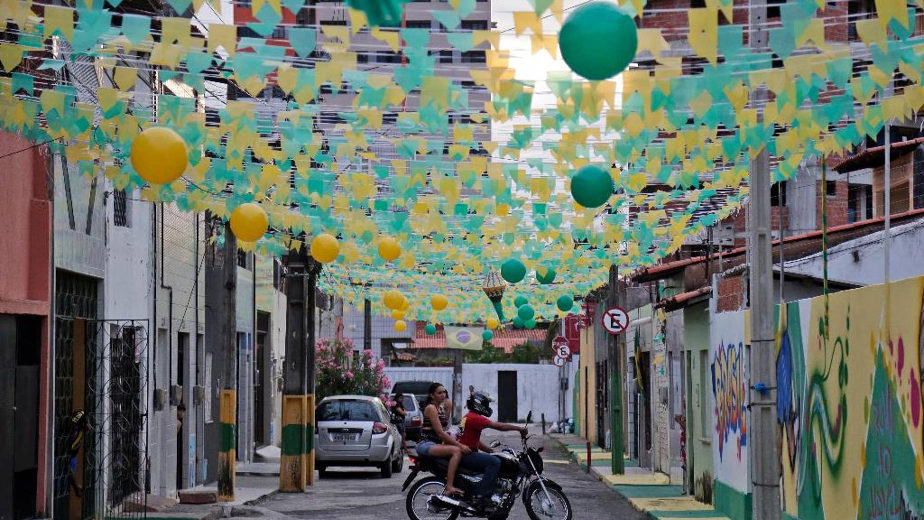 An alley is decorated with the colors of the Brazilian flag during the 2014 soccer World Cup in Fortaleza, Brazil, Monday, June 16, 2014. (AP Photo/Marcio Jose Sanchez)