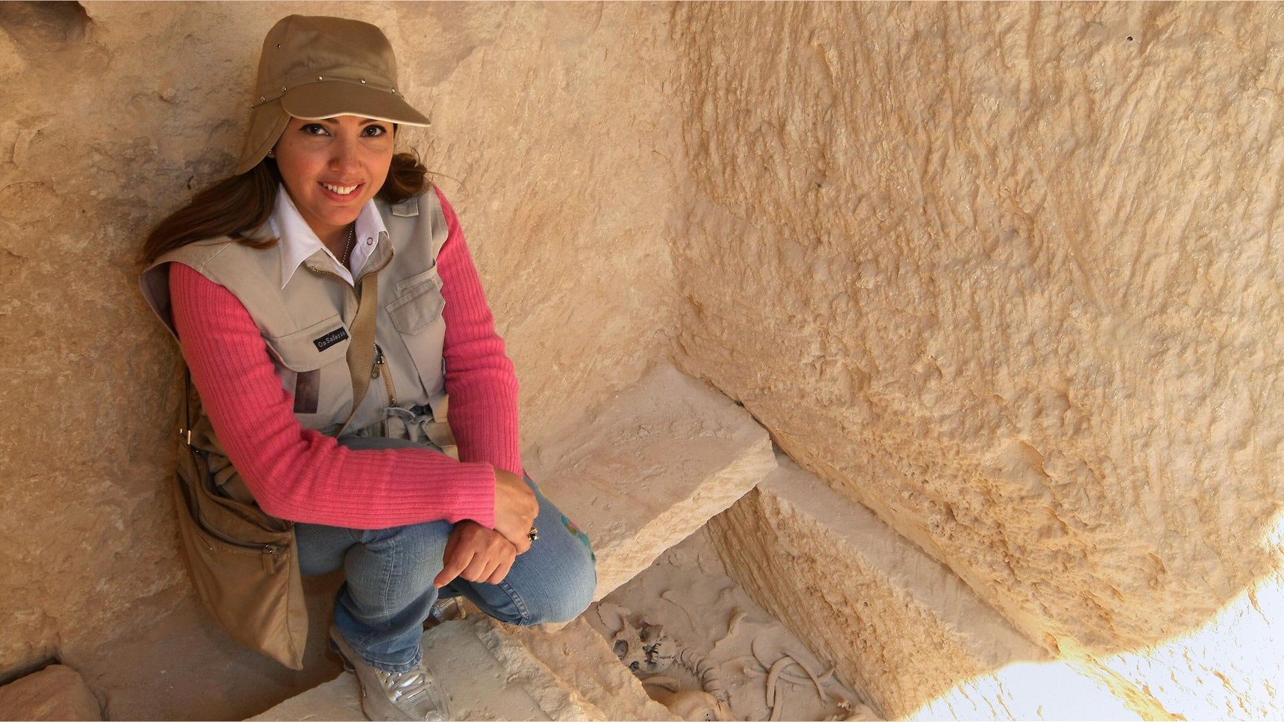 Kathleen Martinez, an Egyptologist from the Dominican Republic, sits near a grave found at the temple of Tasposiris Magna near Borg al-Arab, 50 kms (30 miles) west of Alexandria, on April 19, 2009. Archaeologists searching for the tomb of Marc Anthony and Cleopatra may be closer to locating the burial site of the legendary lovers, Egypt's antiquities council said. A team led by antiquities chief Zahi Hawass and Martinez believes the tomb may be located in three possible sites near the temple and will excavate the three locations next week. AFP PHOTO/CRIS BOURONCLE (Photo credit should read CRIS BOURONCLE/AFP/Getty Images)