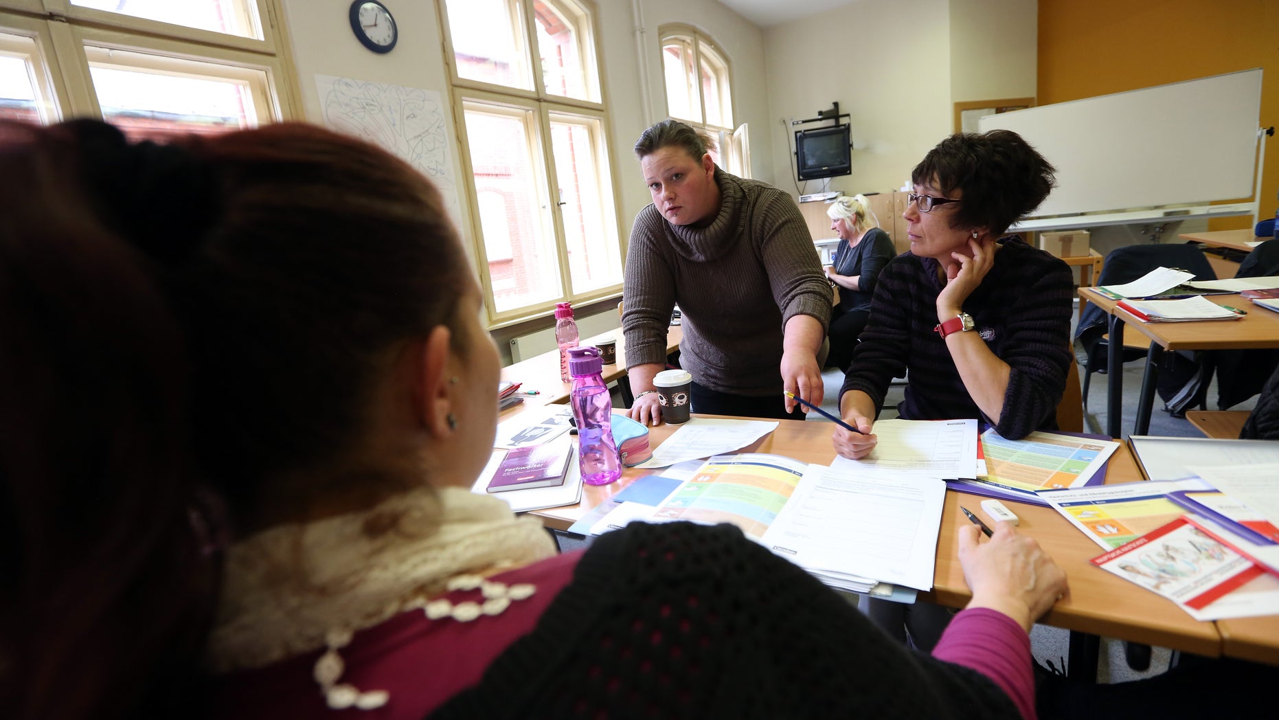 BERLIN, GERMANY - MAY 14: Students go over a lesson during an elderly care training program at the Edith Stein Catholic vocational training center on May 14, 2014 in Berlin, Germany. The supply of caregivers for the elderly in Germany has not met the demand, as an aging population finds itself in need of qualified nurses. According to one study, estimates hold that there will be a shortage of up to 152,000 caregivers by the year 2025. Due to low fertility rates and increased longevity, the elderly population of the country is predicted to increase from 7% of the total population in the previous century to over 10% by the year 2020. (Photo by Adam Berry/Getty Images)