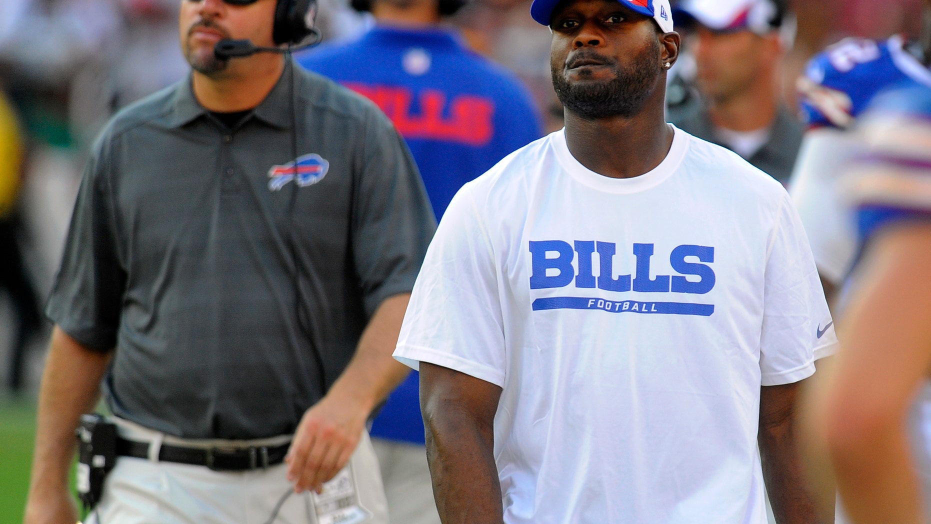 FILE - In this Aug. 24, 2013, file photo, Buffalo Bills safety Jairus Byrd, center, looks on from the sideline in the second half of an NFL preseason football game against the Washington Redskins in Landover, Md. After missing the entire offseason because of a contract dispute and first five games of the regular season due to sore feet, Byrd is finally ready to take the field. Byrd is expected to play Sunday, when the Bills host the Cincinnati Bengals. (AP Photo/Richard Lipski, File)