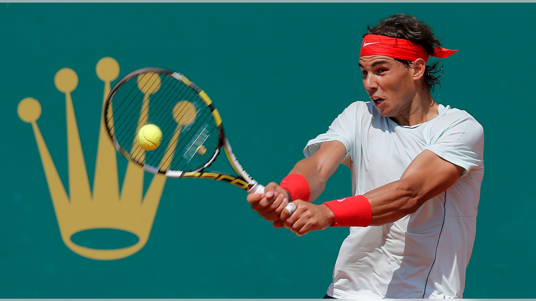 Spain's Rafael Nadal plays a return to Philipp Kohlschreiber of Germany during their match of the Monte Carlo Tennis Masters tournament in Monaco, Thursday, April 18, 2013. (AP Photo/Lionel Cironneau)