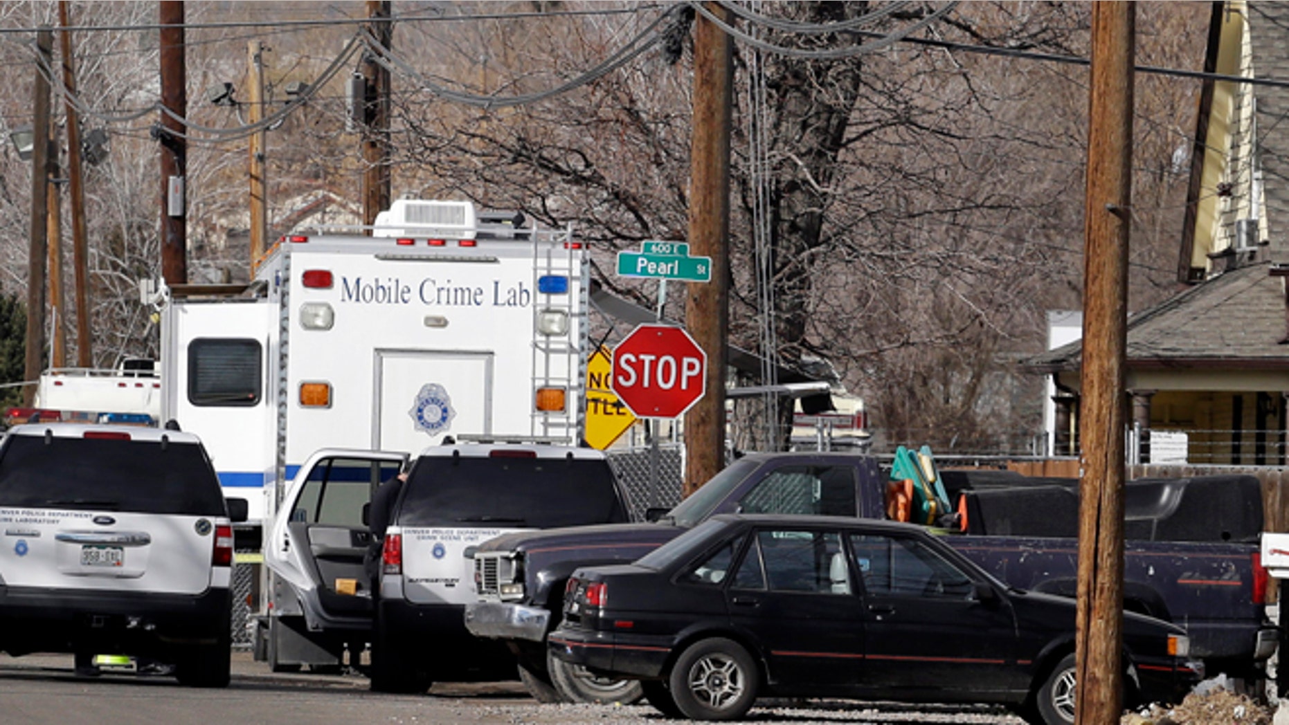 Feb. 6, 2013: Police investigate the scene of a shooting where a woman and two children were found dead and a third child wounded in the Globeville neighborhood in Denver.