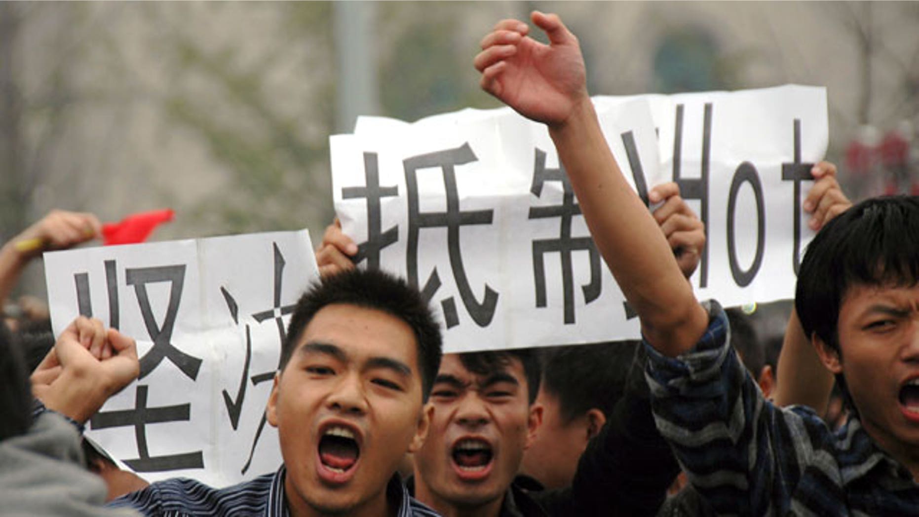 Anti-Japan protesters march with cards calling for a boycott of Japanese products in Wuhan in central China's Hubei province Monday, Oct. 18, 2010. Thousands of Chinese have marched in different Chinese cities in sometimes violent protests since Saturday against Japan and its claim to disputed islands, a show of anger far larger than past protests over the competing territorial claims.