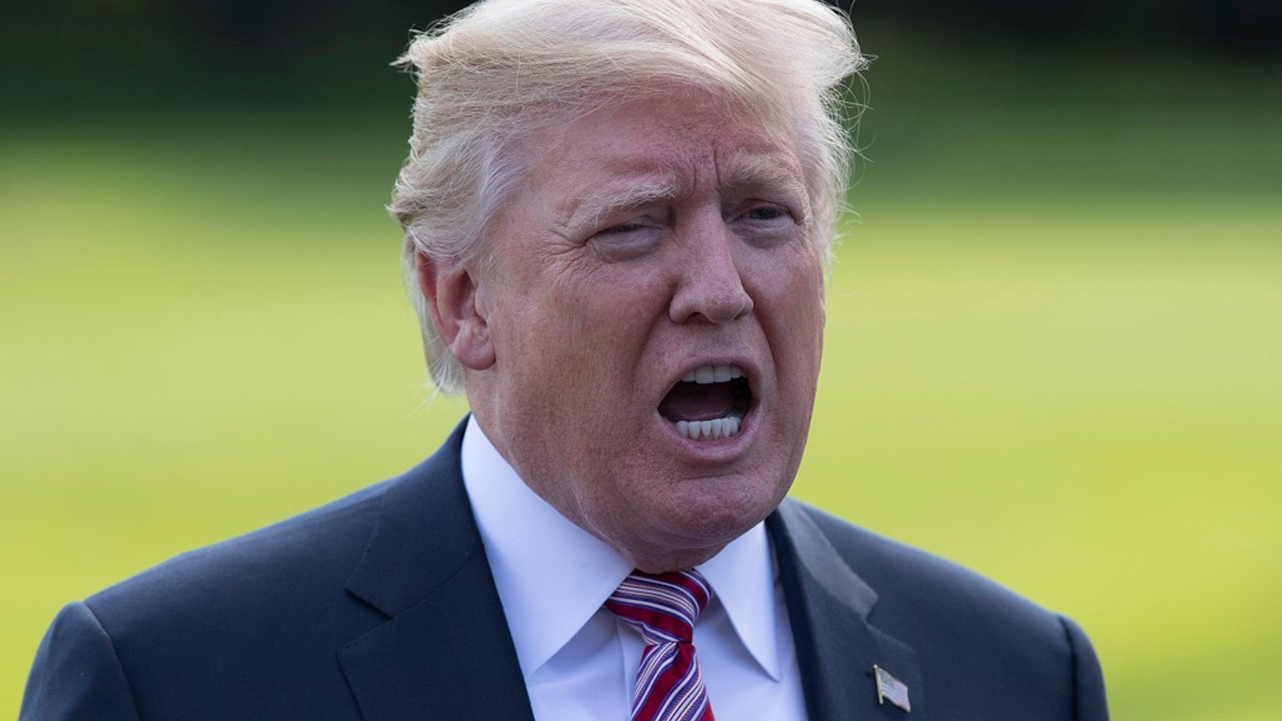 FILE -- In this Sept. 29, 2017 file photo, President Donald Trump talks to media as he walks across the South Lawn of the White House in Washington.