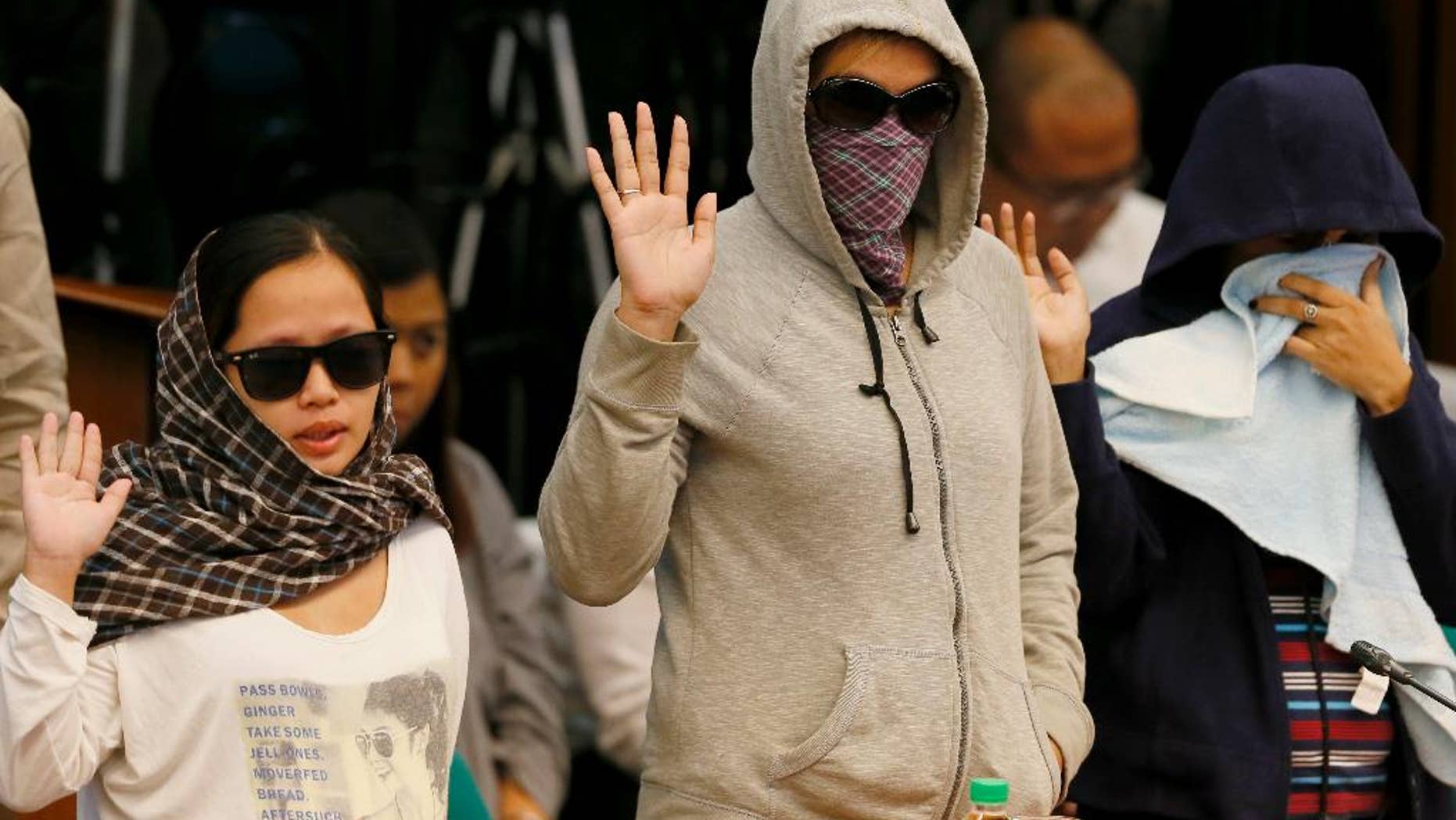 Relatives of victims of alleged extrajudicial killings take their oaths at the start of the Senate investigation in the Philippines. More than 1,700 drug suspects reportedly have been killed since President Rodrigo Duterte assumed office July 1, 2016.