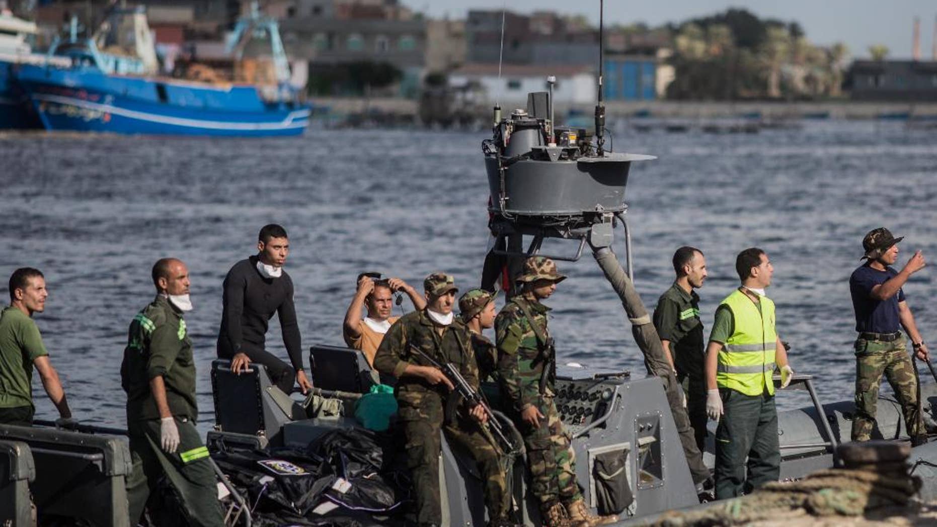 Sept. 22, 2016: Egyptian coast guard and rescue workers bring ashore bodies recovered from a Europe-bound boat that capsized off Egypt’s Mediterranean coast, in Rosetta, Egypt.