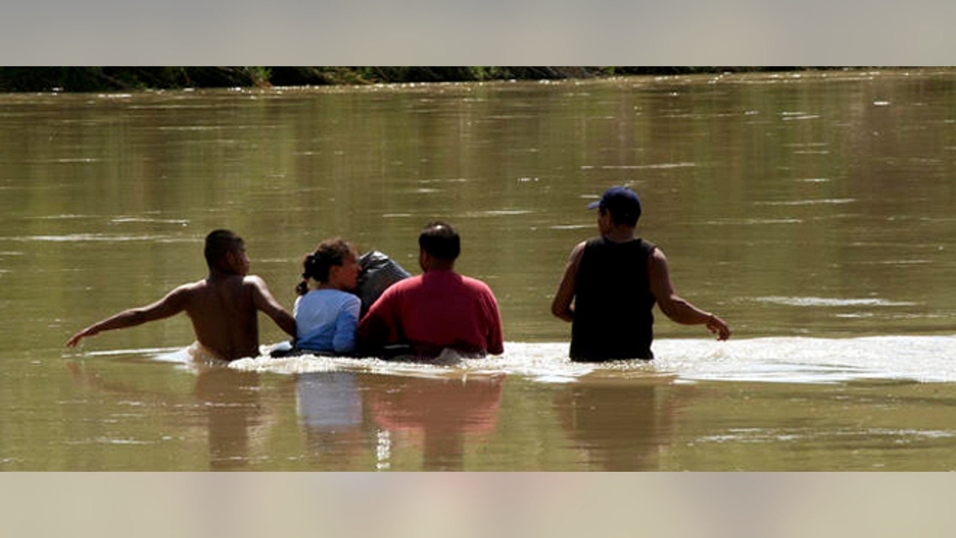 FILE: Undated: Unidentified people in Mexico crossing the Rio Grande to enter the United States illegally, in Nuevo Laredo, Mexico.