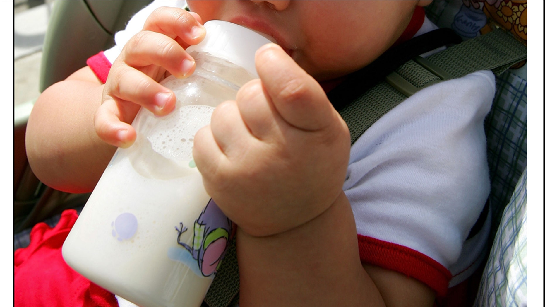 SANTA MARIA, CA - JUNE 9: Michael Jackson fan, Bianca Martinez, eight-months-old, drinks from her baby bottle as she wears a hat with the message "Innocent Like Me" while sitting in her stroller outside the Santa Barbara County Courthouse at the Michael Jackson child molestation trial June 9, 2005 in Santa Maria, California. Jackson is charged in a 10-count indictment with molesting a boy, plying him with liquor and conspiring to commit child abduction, false imprisonment and extortion. (Photo by David Mcnew/Getty Images)