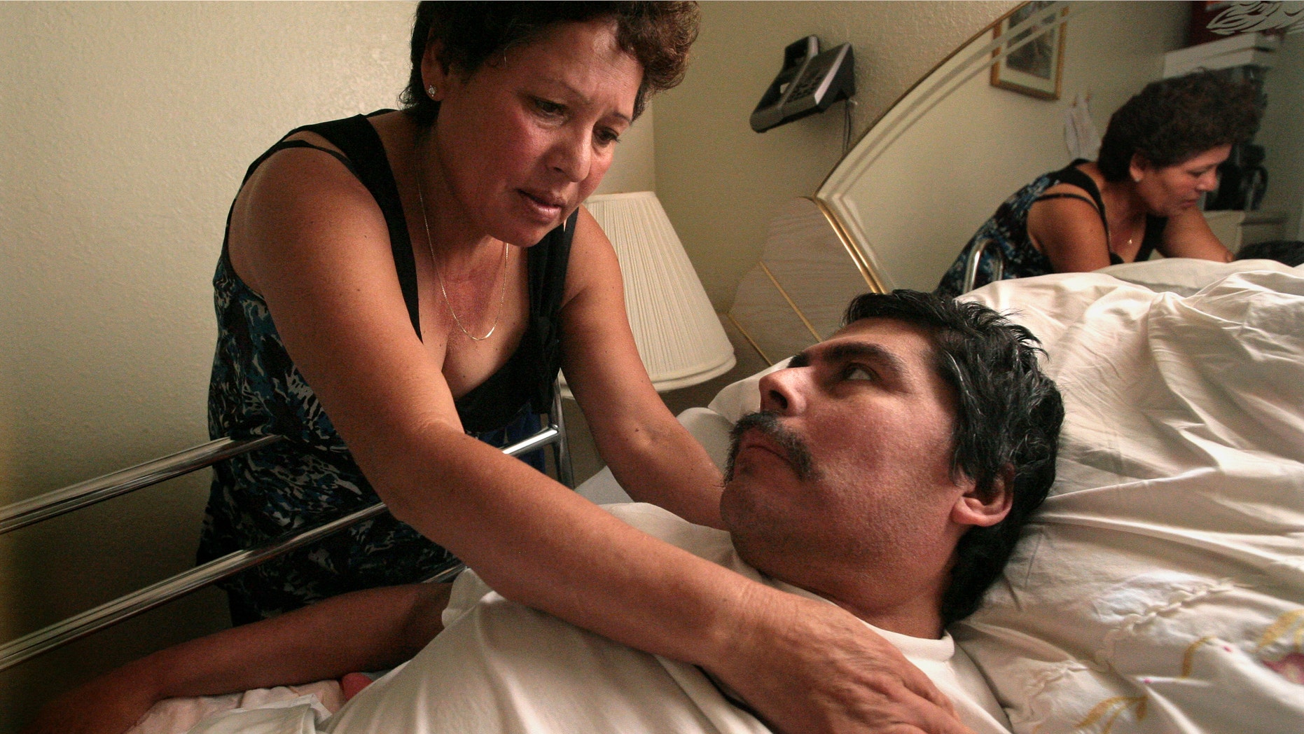 In this Oct. 13, 2008 photo, Lucila Huerta, tends to her husband Guadalupe, who is suffering from Valley Fever and other medical problems, in their apartment in Madera, Calif. Valley Fever, a little-known disease infecting more people nationwide every year, is especially prevalent in Californias San Joaquin Valley. Every day millions of residents in this agricultural region live with the threat of the disease, which is caused by a fungus in the soil. People who work in dusty fields or construction sites are most at risk, but even visitors passing through the valley can contract Valley Fever. (AP Photo/The Fresno Bee, John Walker)