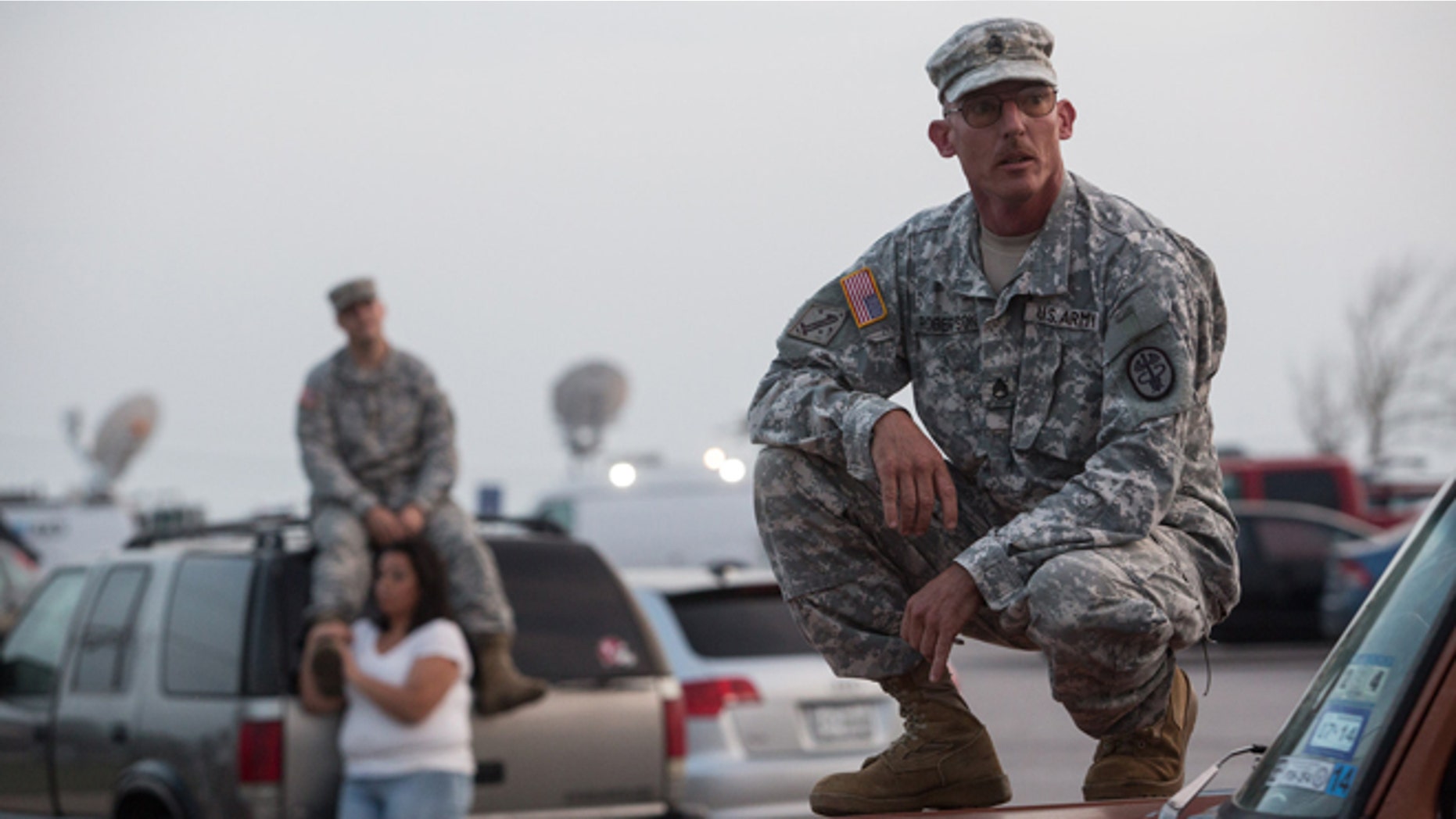 Staff Sgt. John Robertson waits in a parking lot outside of the Fort Hood military base for updates on April 2, 2014.