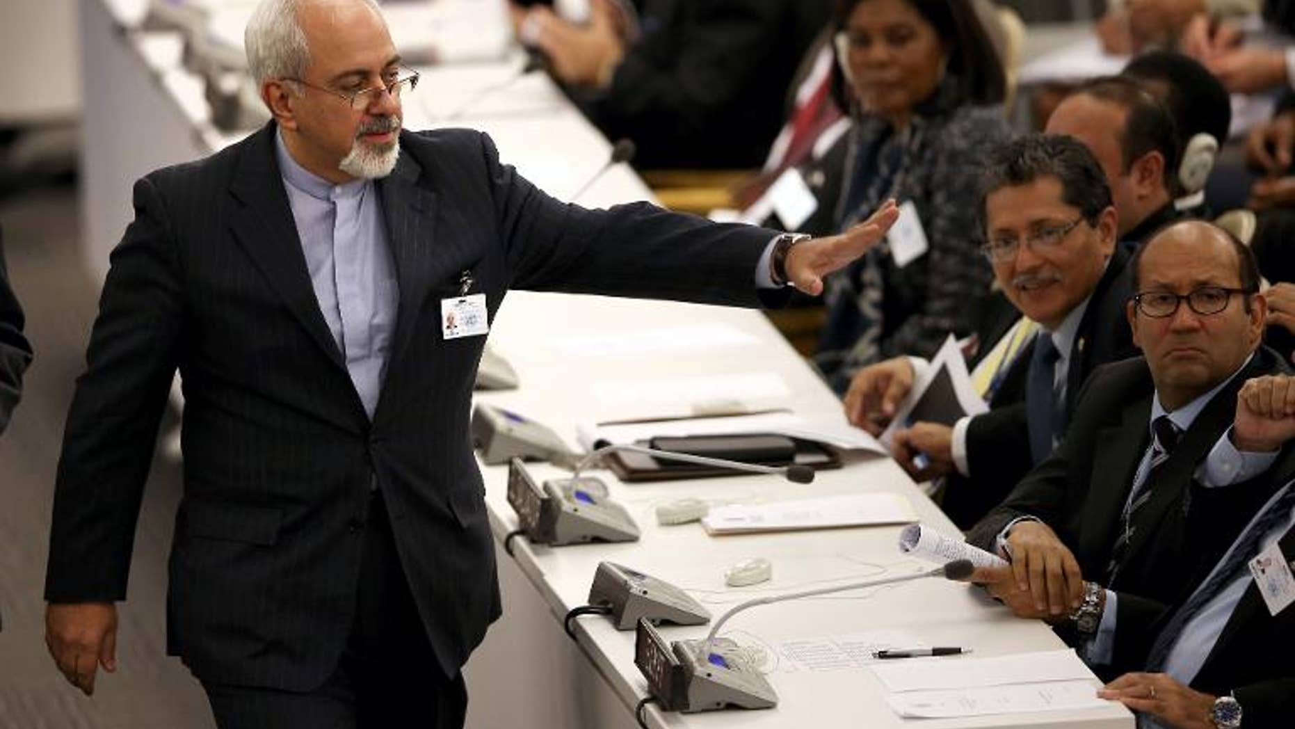 Iranian Foreign Minister Mohammad Javad Zarif greets fellow diplomats after listening to US President Barack Obama address the UN General Assembly on September 24, 2013 in New York