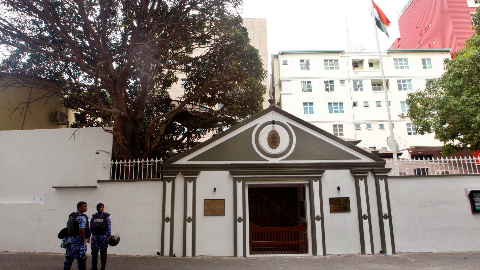 Security personnel stand guard outside the Indian High Commission in Male, Maldives, Wednesday, Feb. 13, 2013. Former president of Maldives Mohamed Nasheed has taken refuge in the Indian High Commission after a Maldivian court issued a warrant and ordered police to arrest him. (AP Photo/Sinan Hussain)
