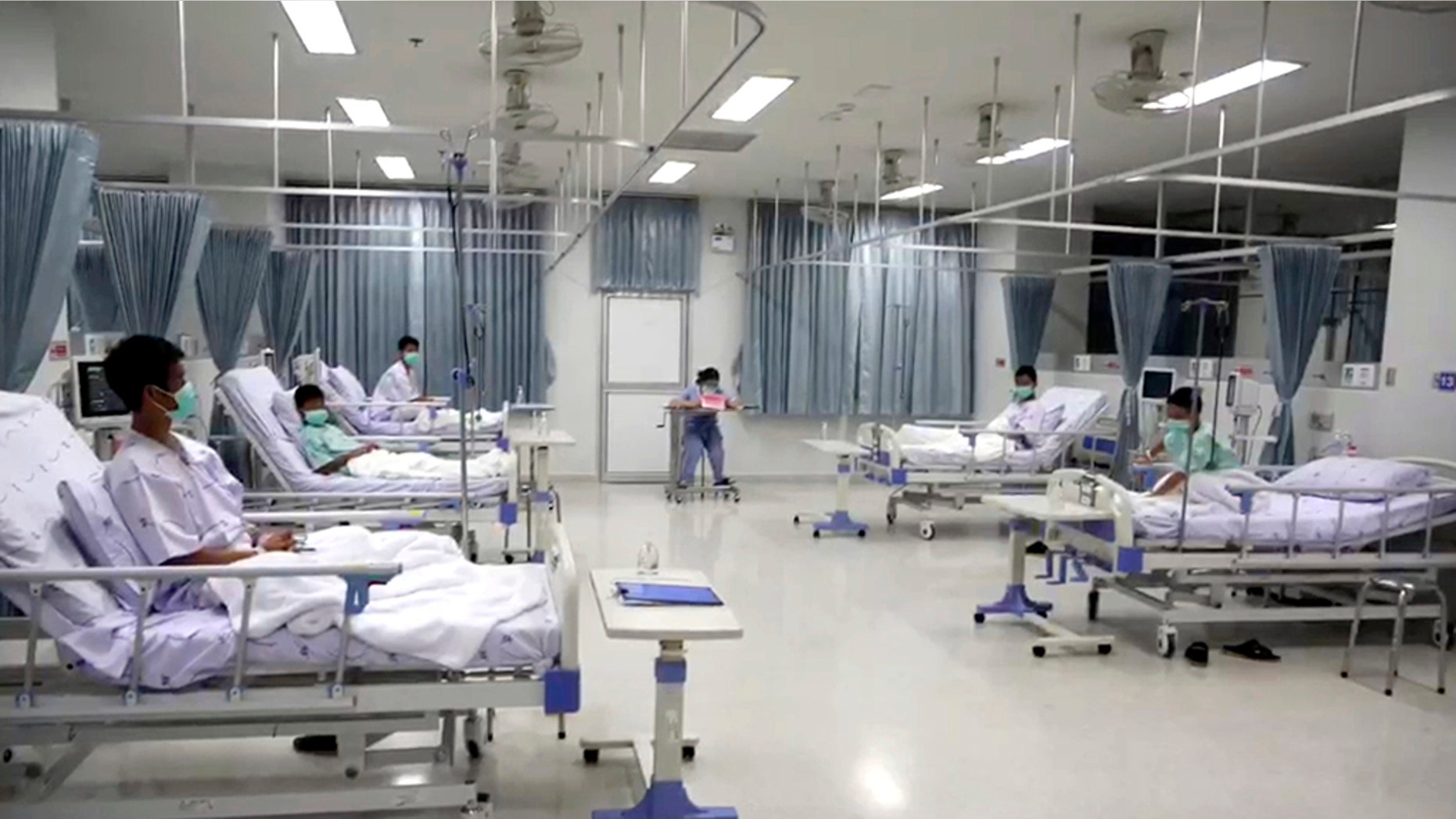 Image made from video shot Friday shows some of the 12 boys rescued from the flooded cave, in their hospital room at Chiang Rai Prachanukroh Hospital in northern Thailand.