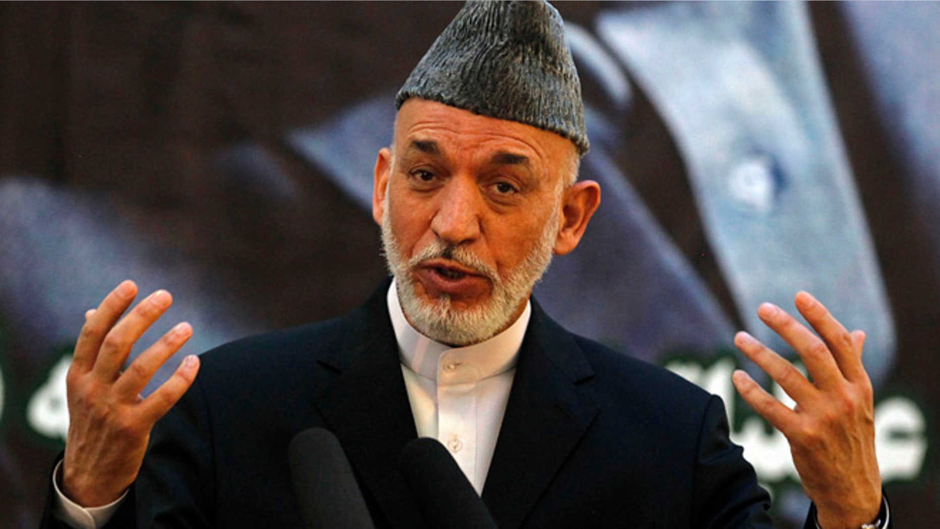June 18, 2013: Afghan President Hamid Karzai speaks during a joint news conference with NATO Secretary-General Anders Fogh Rasmussen following a security handover ceremony at a military academy outside Kabul.