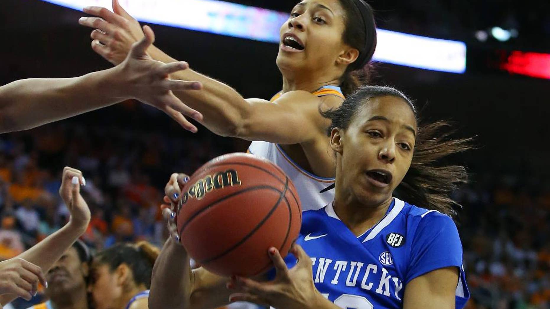 Kentucky forward/center Jelleah Sidney (12) rebounds in front of Tennessee center Isabelle Harrison, top, in the first half of an NCAA college basketball game in the finals of the Southeastern Conference women's tournament on Sunday, March 9, 2014, in Duluth, Ga. (AP Photo/Jason Getz)