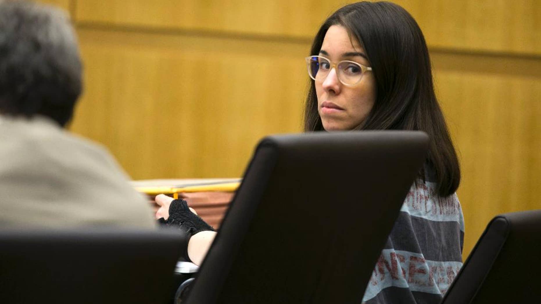 Jodi Arias looks back during an evidentiary hearing regarding allegations of child porn on Travis Alexander's computer in the middle of the sentencing phase of her trial at Maricopa County Superior Court in Phoenix on Thursday, Dec. 11, 2014. Arias was found guilty of first degree murder in the death of former boyfriend Travis Alexander, but the jury was hung on the penalty phase, life in prison or the death sentence. (AP Photo/The Arizona Republic, David Wallace) MARICOPA COUNTY OUT; MAGS OUT; NO SALES
