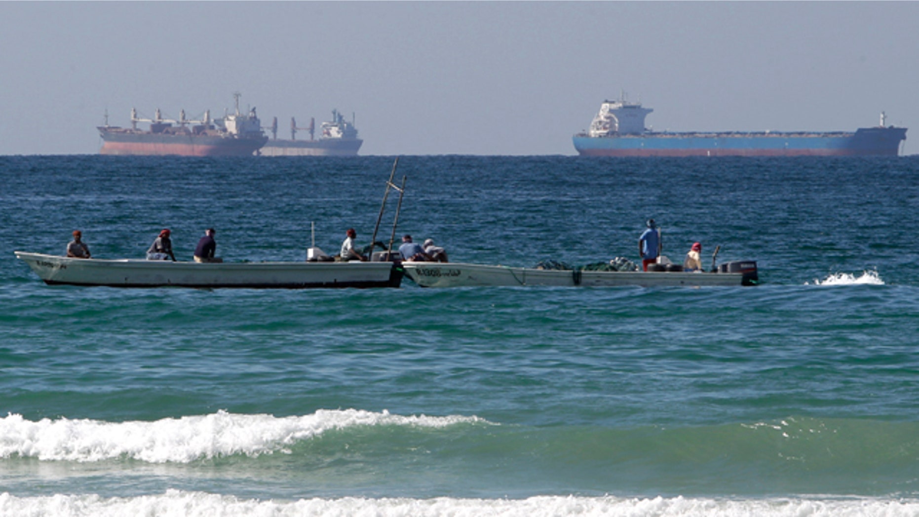 Jan. 19: Fishing boats are seen in front of oil tankers on the Persian Gulf waters, south of the Strait of Hormuz.