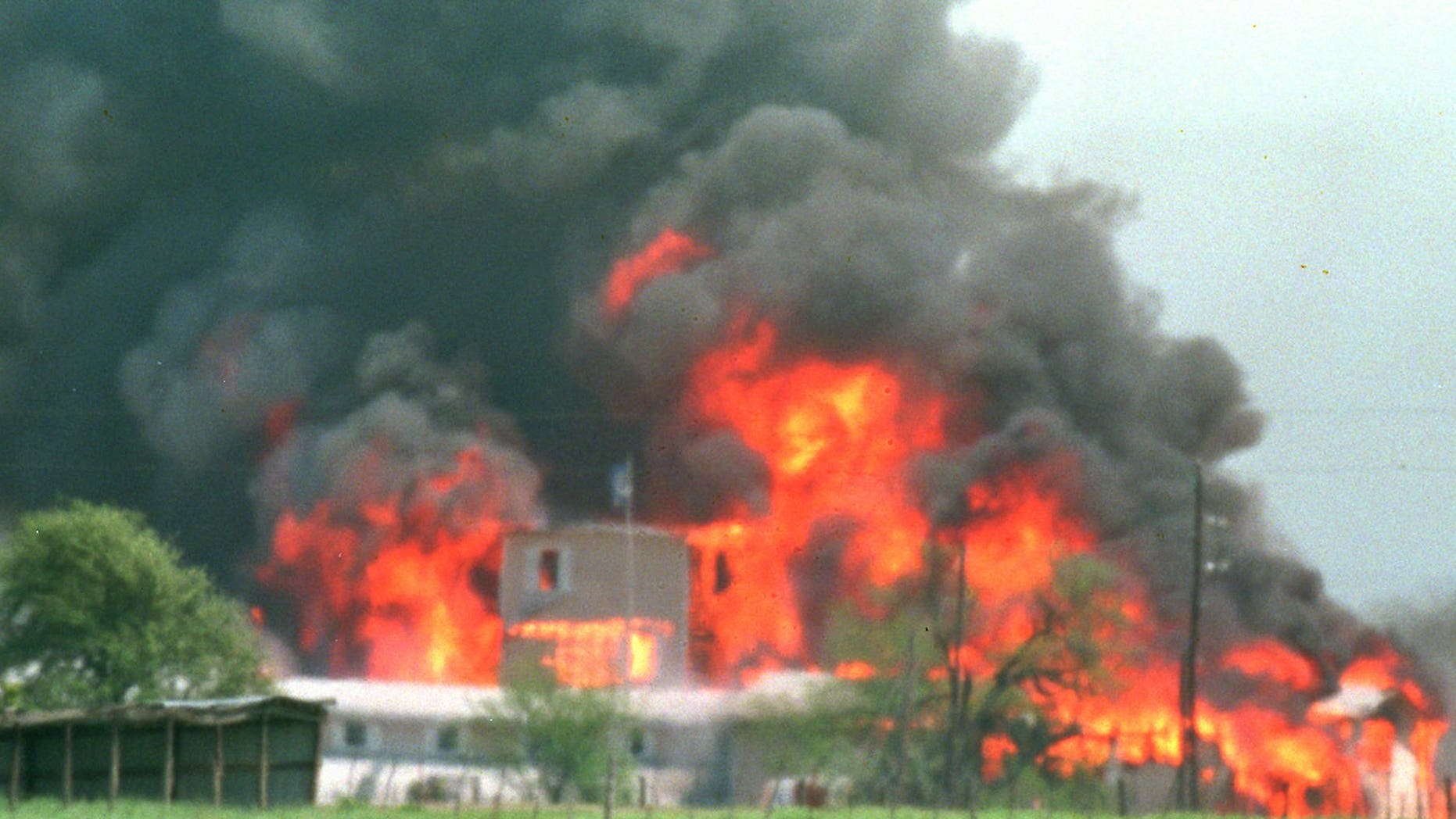 FILE - Fire engulfs the Branch Davidian compound near Waco, Texas, in this April 19, 1993 file photo. Some who survived the fiery end to the 51-day standoff at the Branch Davidians' Central Texas compound are to gather for a memorial service on the 20th anniversary of the fire Friday April 19, 2013. (AP Photo/Ron Heflin, File)