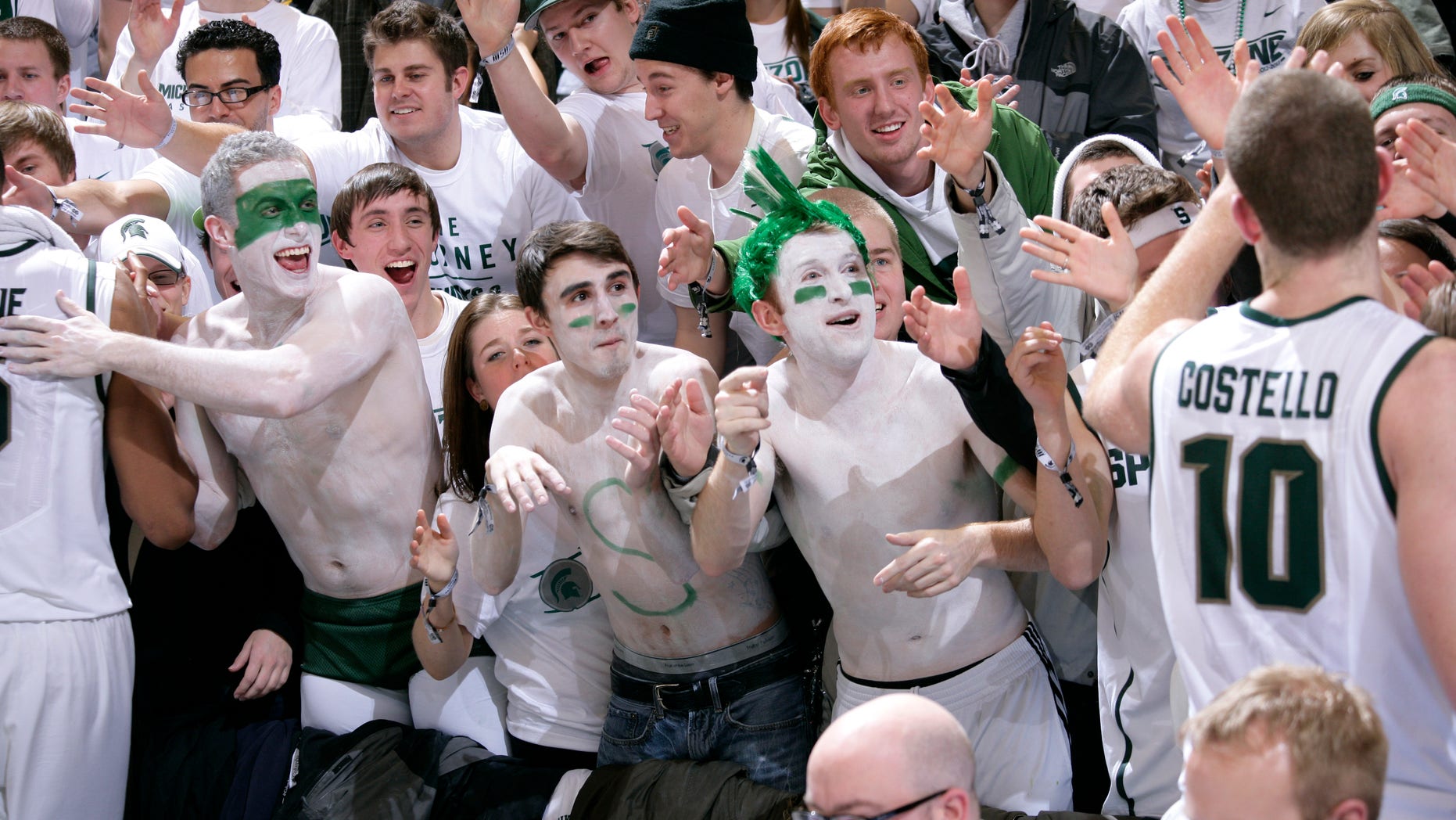 Michigan State fans greet players, including Matt Costello (10), following a 75-52 win over Michigan in an NCAA college basketball game, Tuesday, Feb. 12, 2013, in East Lansing, Mich. (AP Photo/Al Goldis)