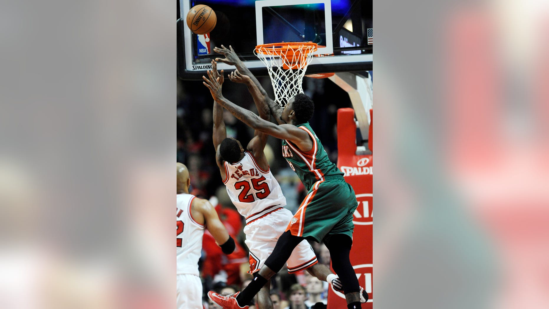 Chicago Bulls' Marquis Teague (25), goes up for a rebound against Milwaukee Bucks' Larry Sanders (8), during the first half of an NBA preseason basketball game in Chicago, Monday, Oct. 21, 2013. (AP Photo/Paul Beaty)