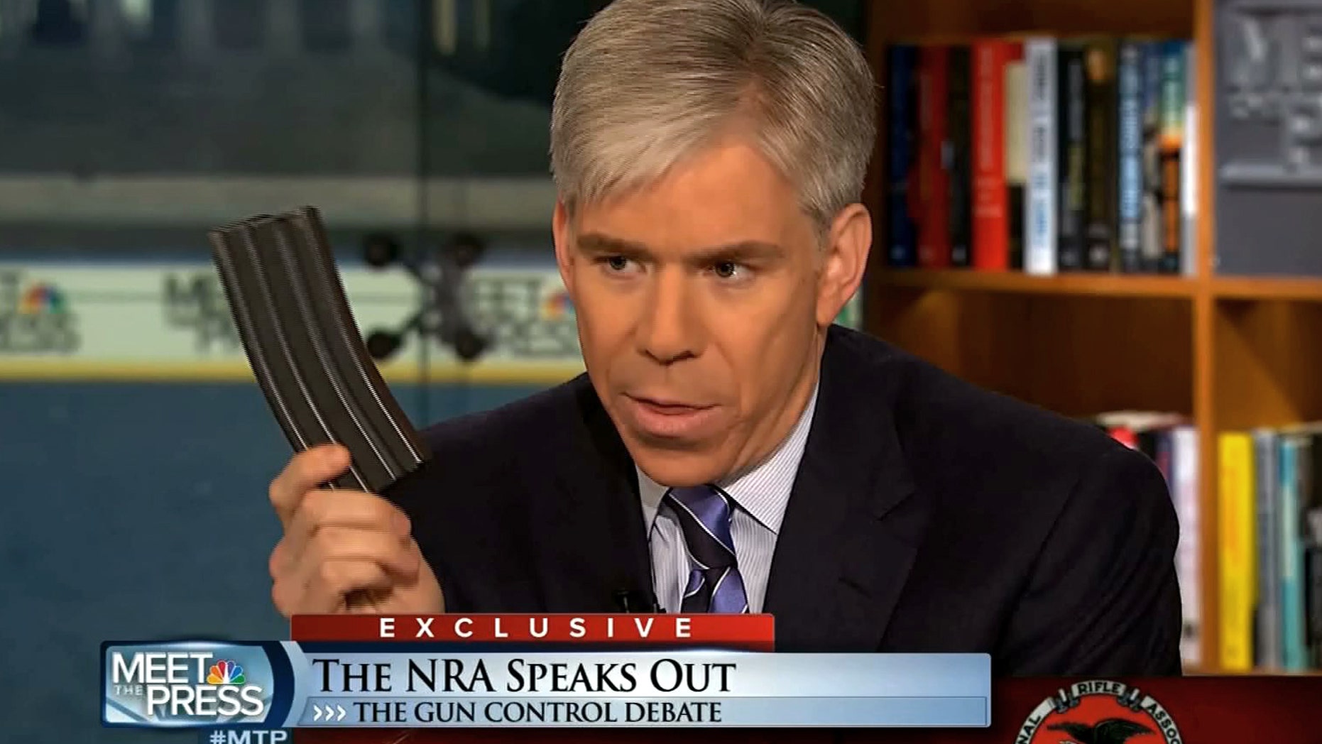 This image made from video provided by NBC's "Meet the Press" shows host David Gregory holding what he described as a high-capacity ammunition magazine during the taping of the Sunday, Dec. 23, 2012 program. He was interviewing National Rifle Association executive vice president Wayne LaPierre and used the magazine as a prop while discussing gun control. Gregory won't face charges for possession of a high-capacity magazine D.C. prosecutors announced Friday, Jan. 11, 2013 saying criminal charges wouldn't serve the public's best interests. (AP Photo/Meet the Press)