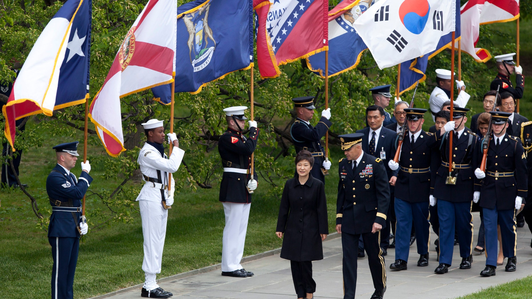 Visiting South Korea President Park Geun-hye, center left, is escorted by Maj. Gen. Michael Linnington, as they march past the colors of American states, during a wreath laying ceremony at the Tomb of the Unknowns at Arlington National Cemetery in Arlington, Va., Monday, May 6, 2013. (AP Photo/Manuel Balce Ceneta)