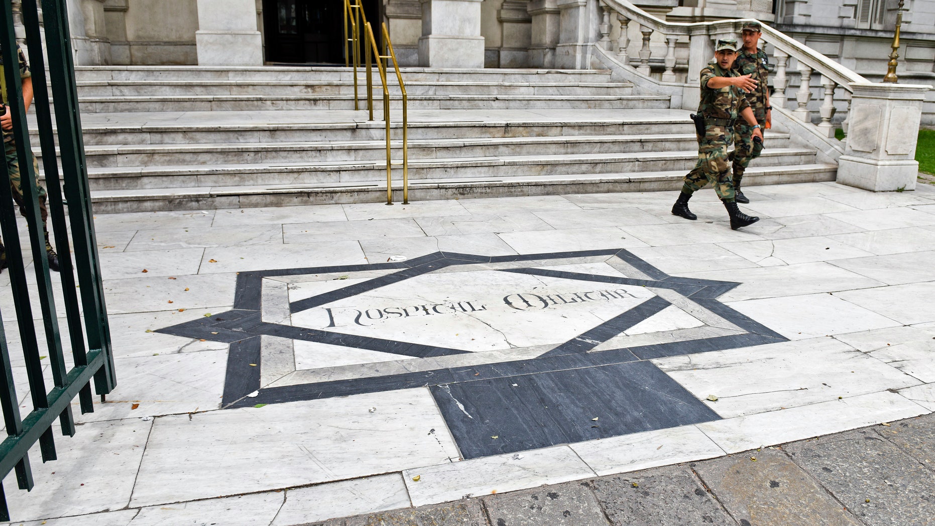 Two military leave the military hospital in Montevideo, Uruguay, Sunday, Dec. 7, 2014.