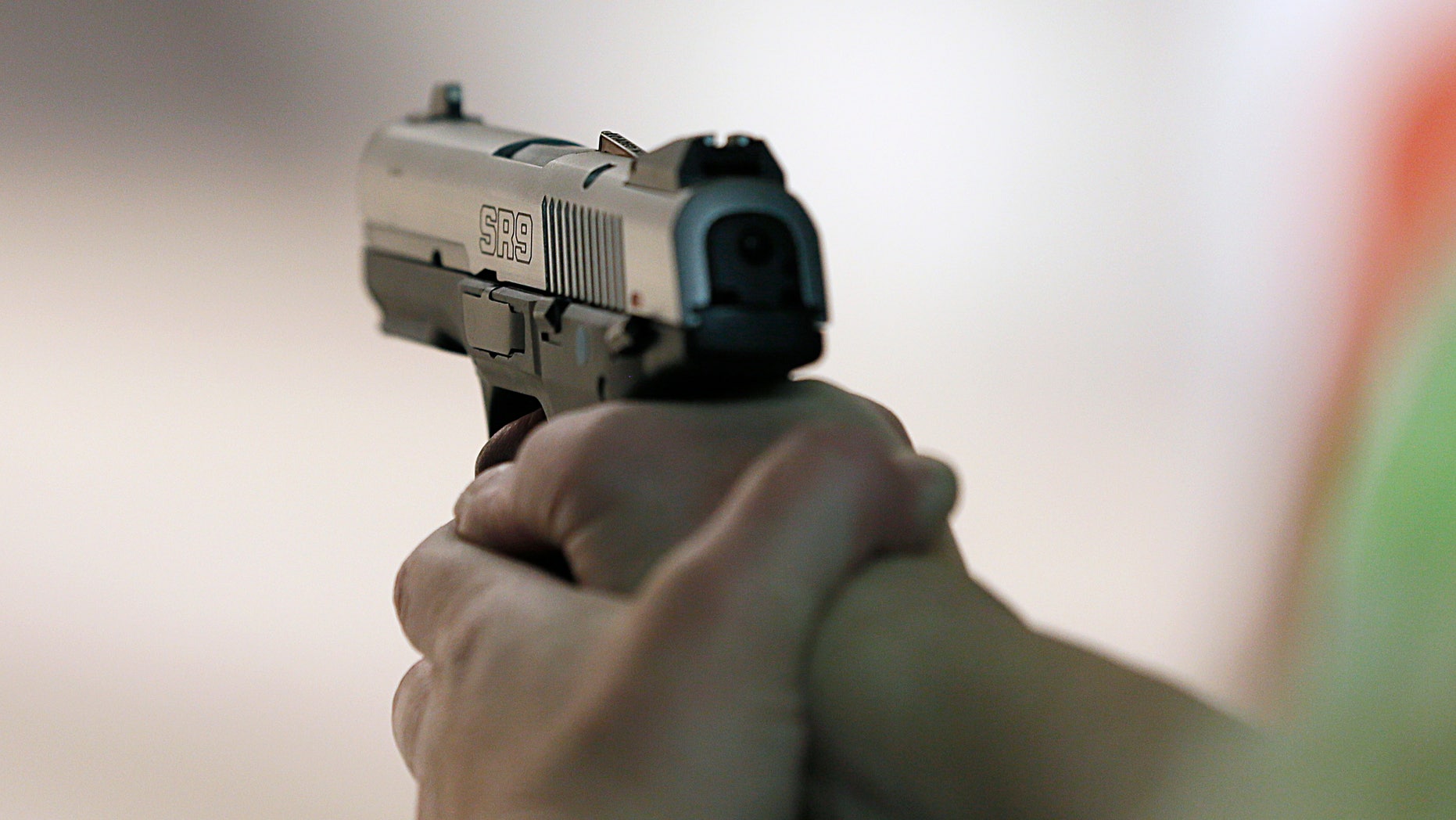 SALT LAKE CITY, UT - JANUARY 15: A women fires a handgun at the "Get Some Guns & Ammo" shooting range on January 15, 2013 in Salt Lake City, Utah. Lawmakers are calling for tougher gun legislation after recent mass shootings at an Aurora, Colorado movie theater and at Sandy Hook Elementary School in Newtown, Connecticut. (Photo by George Frey/Getty Images)