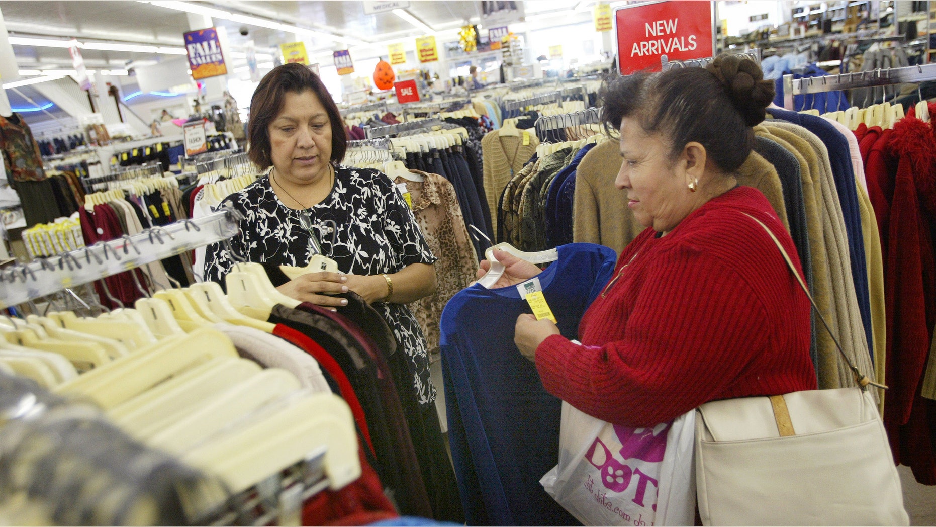 CHICAGO - OCTOBER 24: Sales associate Maria Ayala (L) helps Carmen Anzo shop for clothing in a store located in Chicago's largely Hispanic Little Village neighborhood October 24, 2003 in Illinois. According to the U.S. Census Bureau, reports show that the nation's Hispanic population has grown to become the largest minority. (Photo by Tim Boyle/Getty Images)