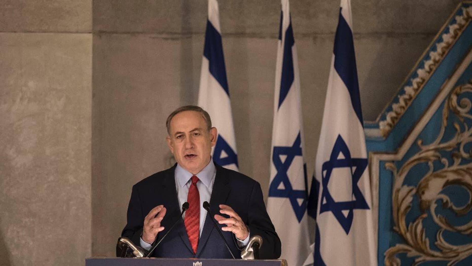 Israeli Prime Minister Benjamin Netanyahu speaks in the synagogue at the Yad Vashem Holocaust Memorial Museum, in Jerusalem, Thursday, Jan. 26, 2017. In remarks at the Holocaust ceremony on Thursday, Netanyahu said President Donald Trump understands the "danger" stemming from the Iran nuclear deal. (AP Photo/Tsafrir Abayov)