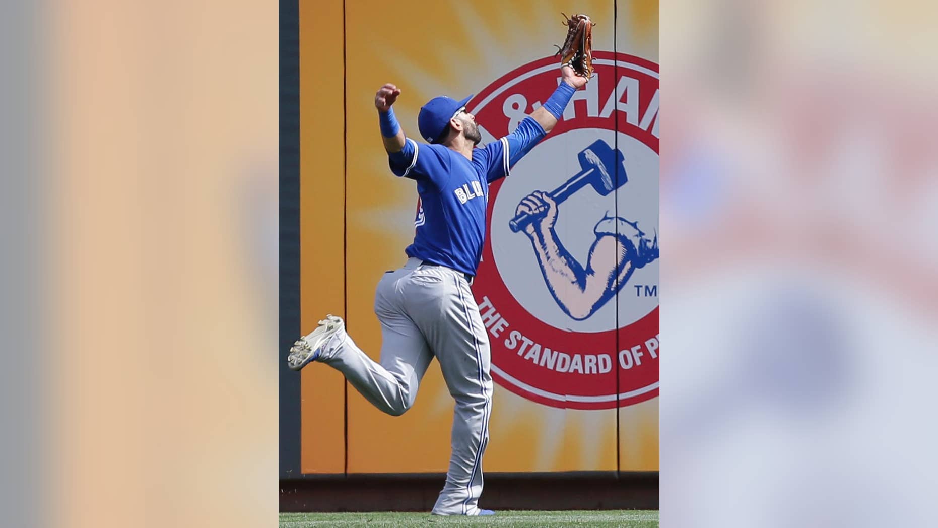 Toronto Blue Jays right fielder Jose Bautista catches a line drive hit by Cincinnati Reds' Todd Frazier in the first inning of a baseball game on Saturday, June 21, 2014, in Cincinnati. (AP Photo/Al Behrman)