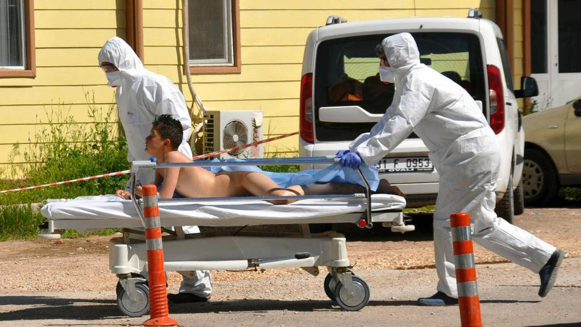 Turkish experts evacuate a victim of a suspected chemical weapons attacks in the Syrian city of Idlib, at a local hospital in Reyhanli, Turkey, Tuesday, April 4, 2017. A suspected chemical attack in a town in Syria's rebel-held northern Idlib province killed dozens of people on Tuesday, opposition activists said, describing the attack as among the worst in the country's six-year civil war. (DHA-Depo Photos via AP)